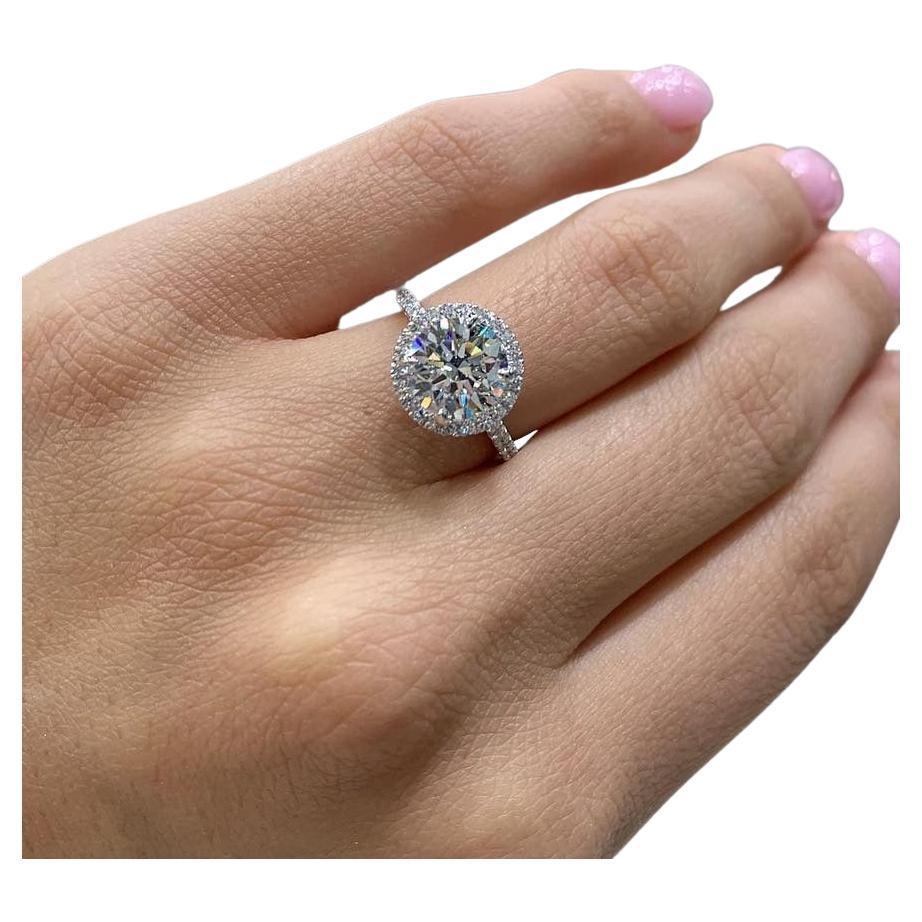 An extraordinary This dazzling and substantial 3.70 carat round brilliant cut diamond is bright white, completely eye clean, and impeccably finished! Cut with absolutely ideal proportions, it displays truly phenomenal sparkle!

The diamond is
