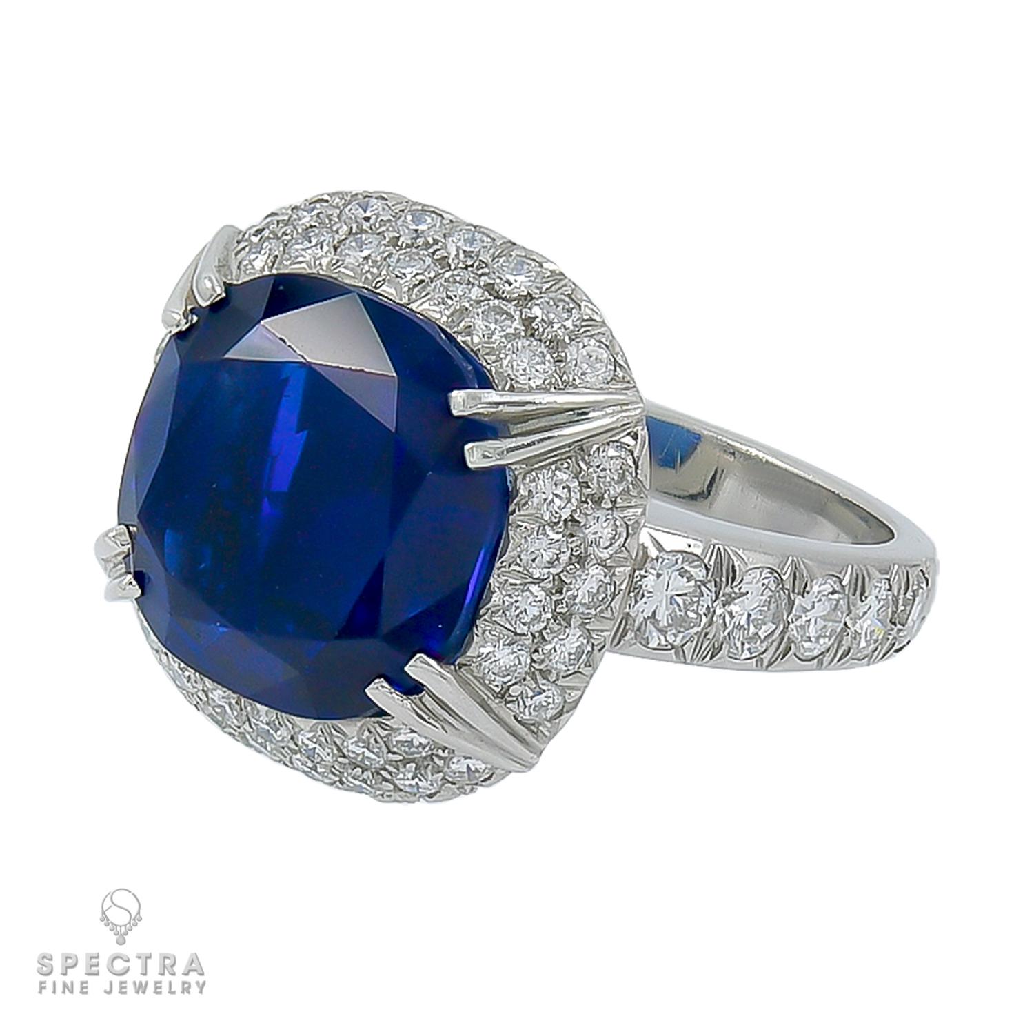 A cocktail ring showcasing a cushion blue sapphire weighing a total of 9.57 carats. 
The sapphire is certified by Gubelin lab, stating that it's of Burmese origin with no indication of heating.
The center stone has a double halo with pave diamonds.