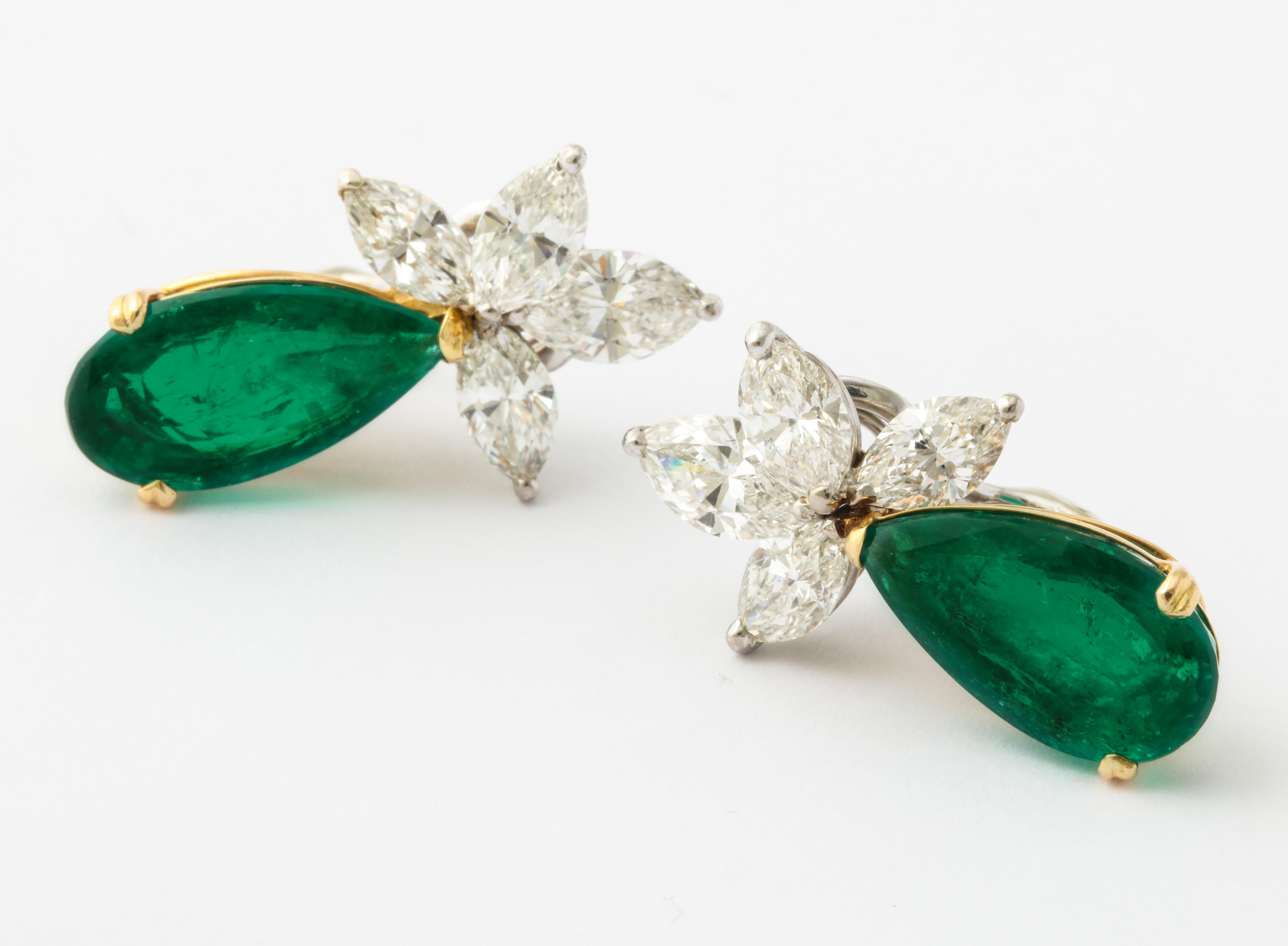 The beautifully matched pair of 5 carat Colombian emeralds hang delicately off of marquise diamond clusters in an elegant and timeless fashion.  

1 pear shape emerald 5.03cts (Gubelin certificate)
1 pear shape emerald 5.61cts (Gubelin
