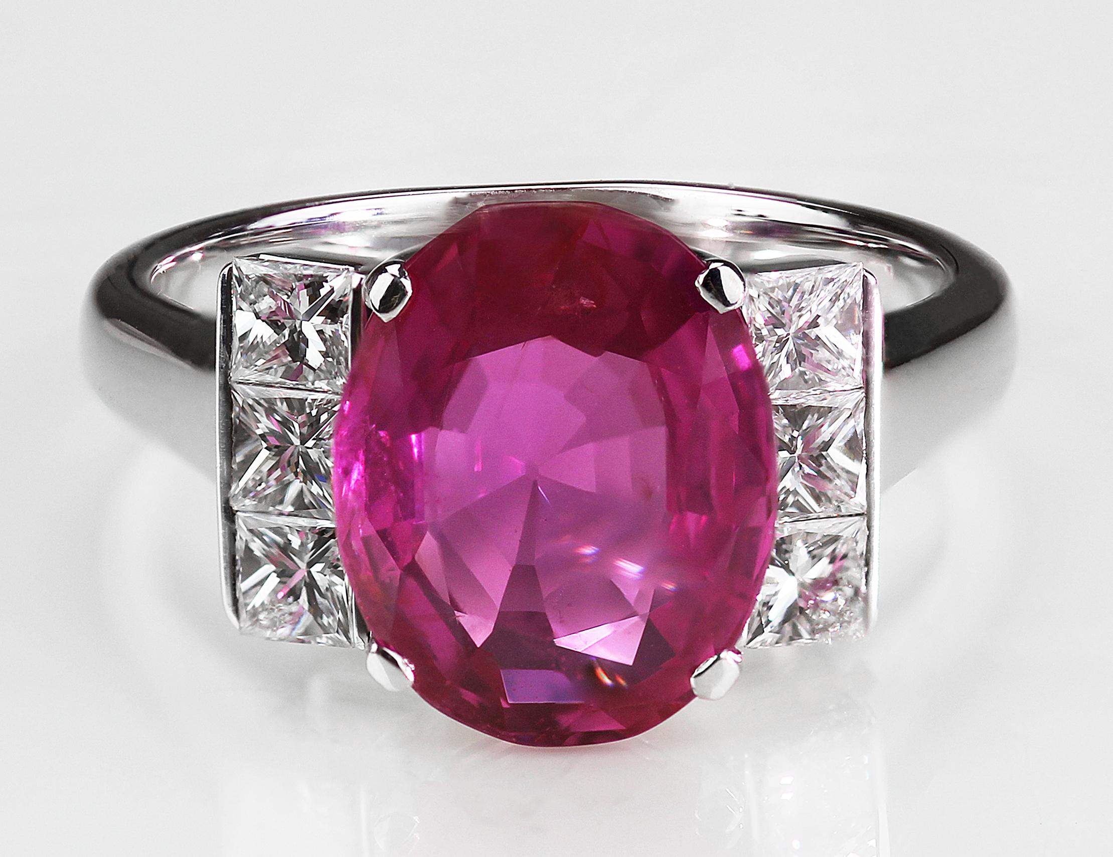 Gorgeous oval cut pinks sapphire and diamond shoulders ring consisting of a stunning vivid red-pink colour sapphire complimented with an icy glistening white of the princess cut diamonds beside it, set on on a 18ct white gold band.
1 x Oval cut Pink