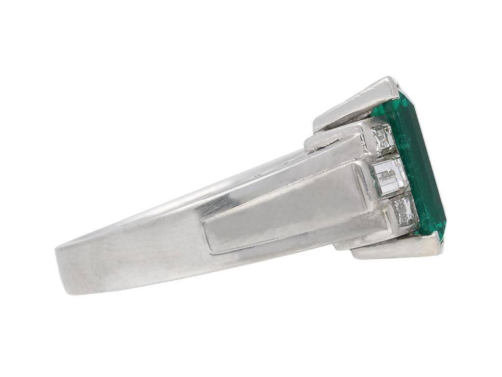 Gubelin Colombian emerald and diamond ring. Set with a rectangular step cut natural Colombian Muzo emerald with no colour enhancement in an open back corner claw setting with an approximate weight of 1.80 carats, flanked by six stepped horizontally