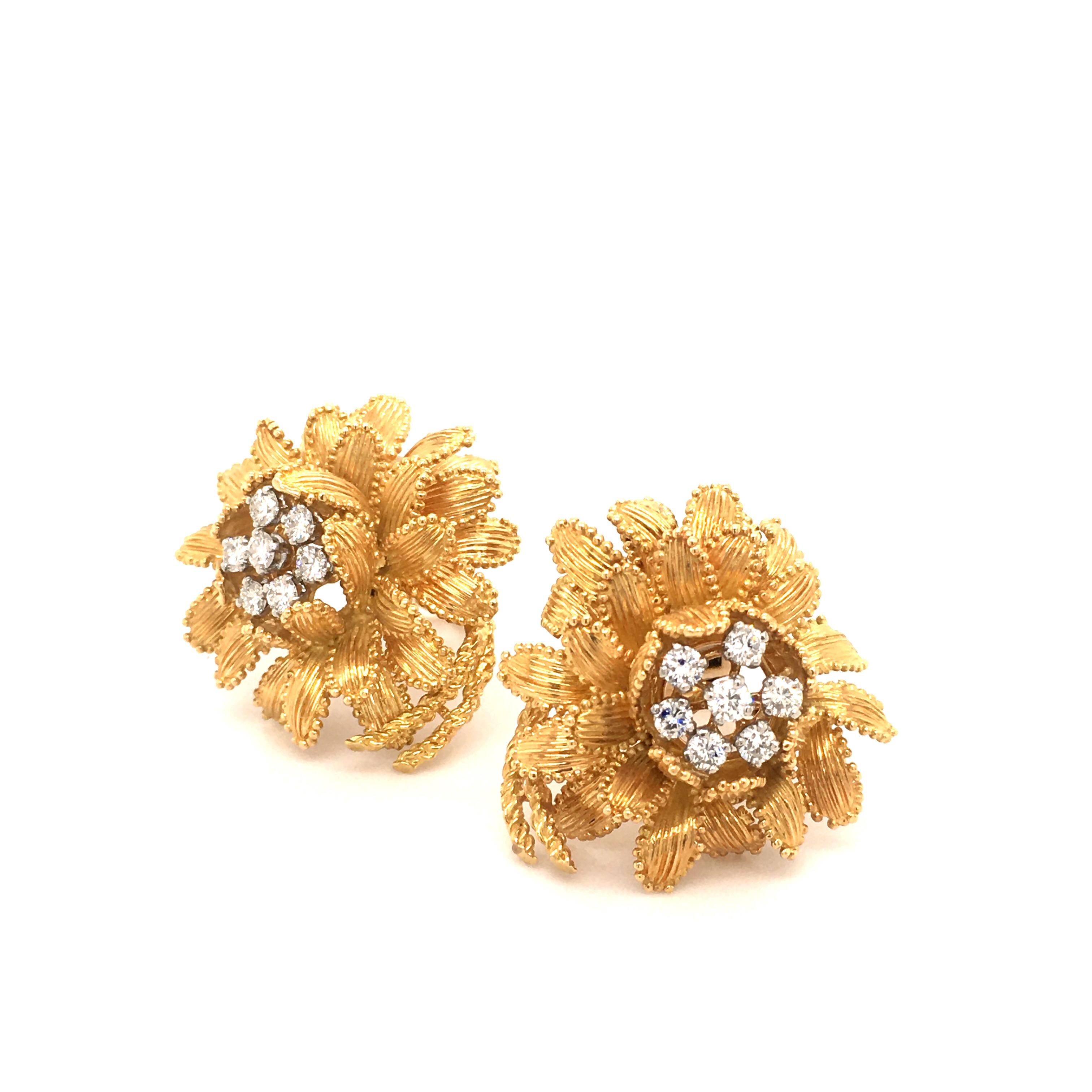 This beautifully handcrafted flower earclips by Gubelin in 18 karat yellow and white gold are prong set with 14 brilliant cut diamonds of G/H color and vs clarity, total weight 0.93 carats. 
Each leaf is carefully bordered by minute granulated