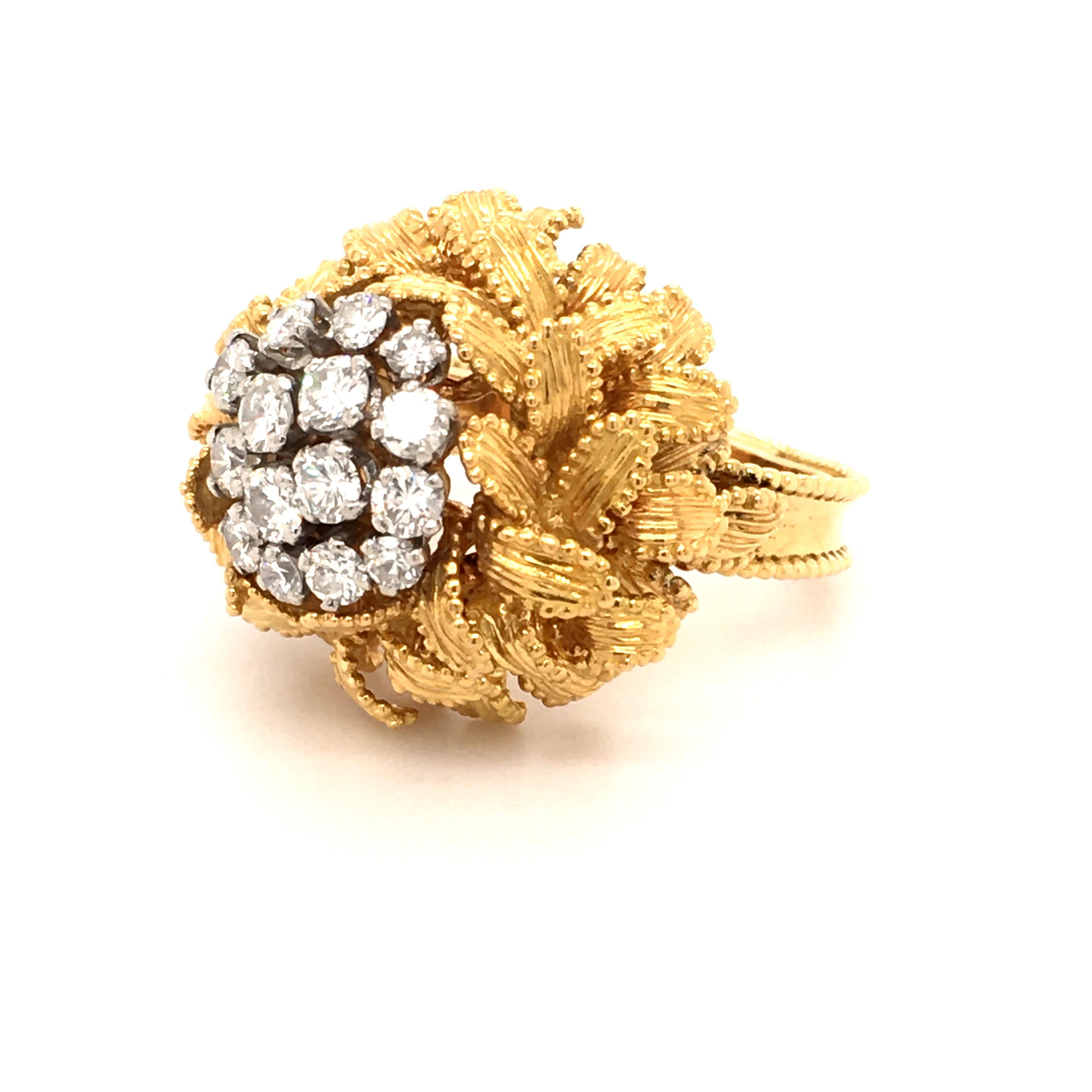 This beautifully handcrafted ring by Gubelin in 18 karat yellow and white gold is prong set with 15 brilliant cut diamonds of G/H color and vs clarity, total weight 1.06 carats. 
Each leaf is carefully bordered by minute granulated spheres.

Signed