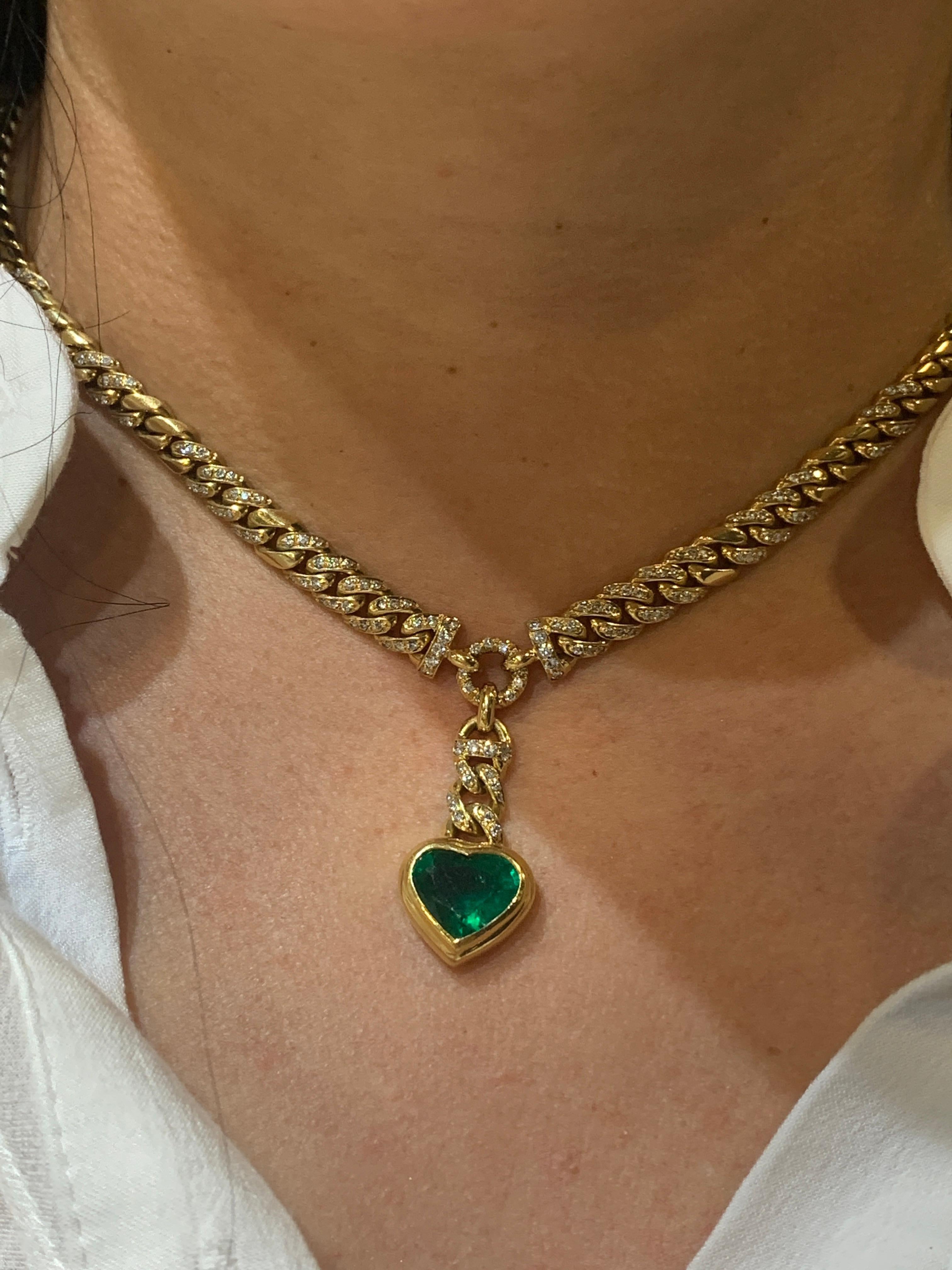 18k gold curb link necklace set with diamonds, and suspending a further chain and bezel set heart-shape emerald. Purchased in 1983. Emerald weight - 4.00 carats, diamond weight - 1.69 carats. Signed with Gubelin marker's mark , 1106 NJ. Length - 16