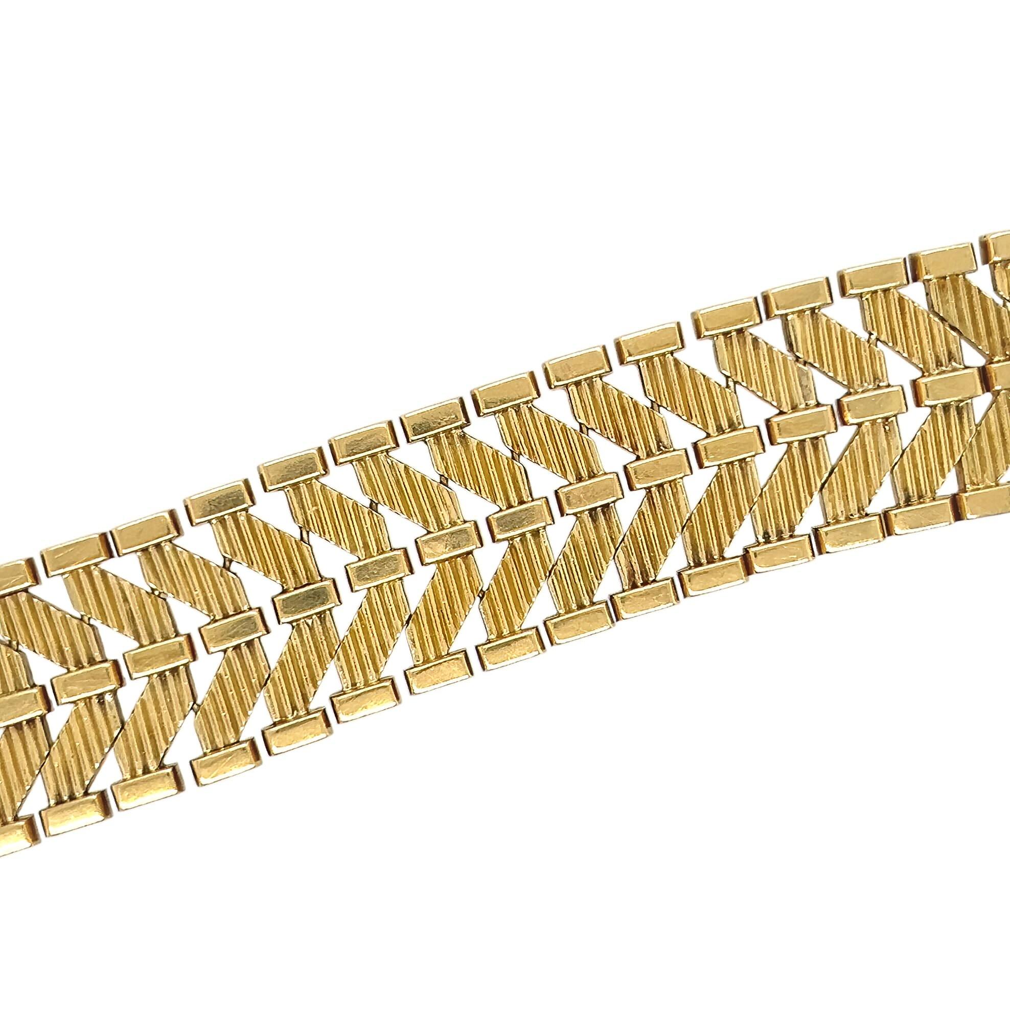 Un bracelet en or jaune 18 carats. Gubelin. Conçue comme une bande texturée et polie à motif de chevrons. La longueur est d'environ 8 pouces, le poids brut est d'environ 98,9 grammes. Signés et numérotés.