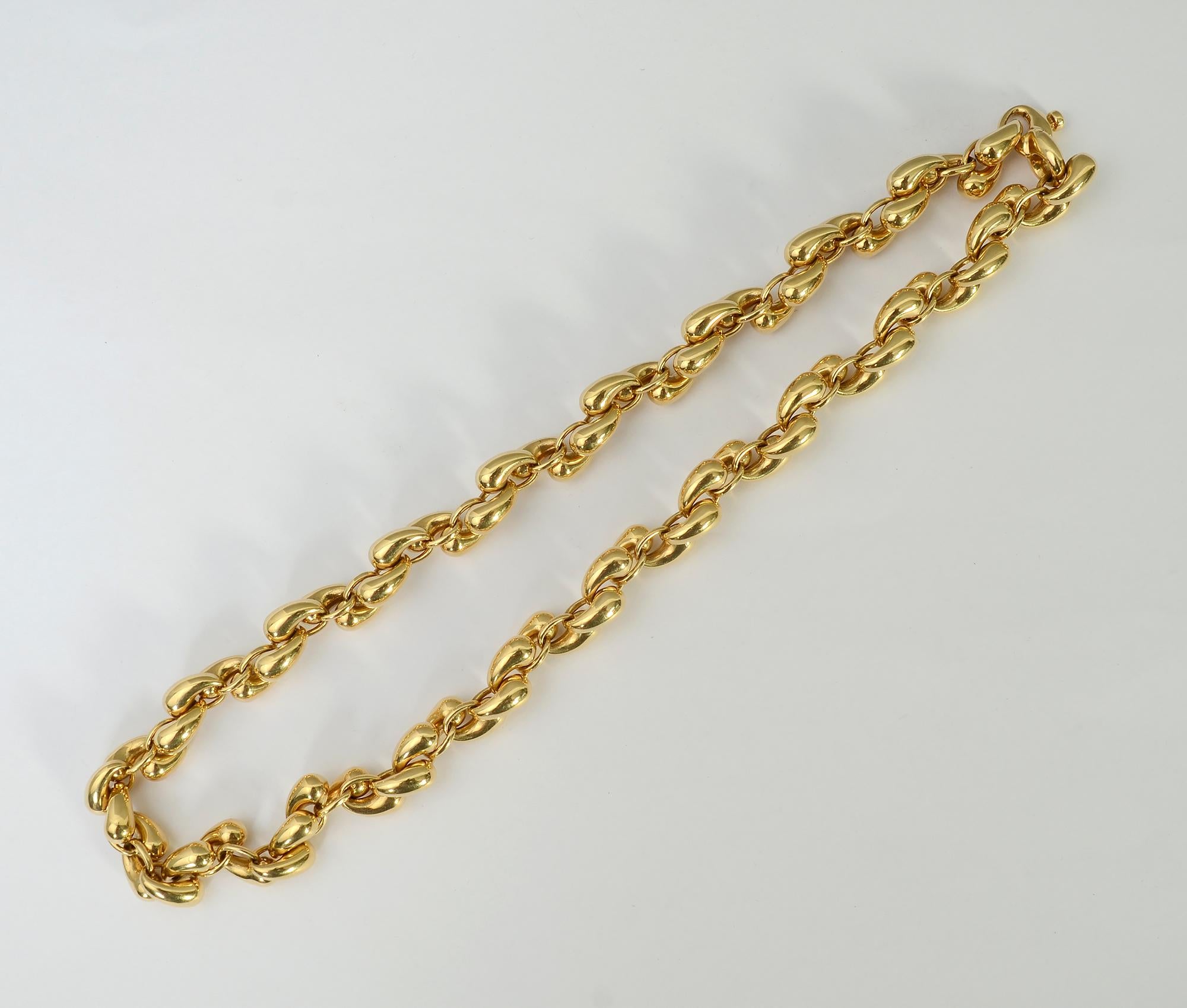 Gubelin 18 karat gold necklace with most unusual links. Each goes from narrow to a curved bulbous shape. Were it not for the sapphire , the clasp would be virtually invisible. The necklace is 18 inches long; links are 1/4 inch wide.