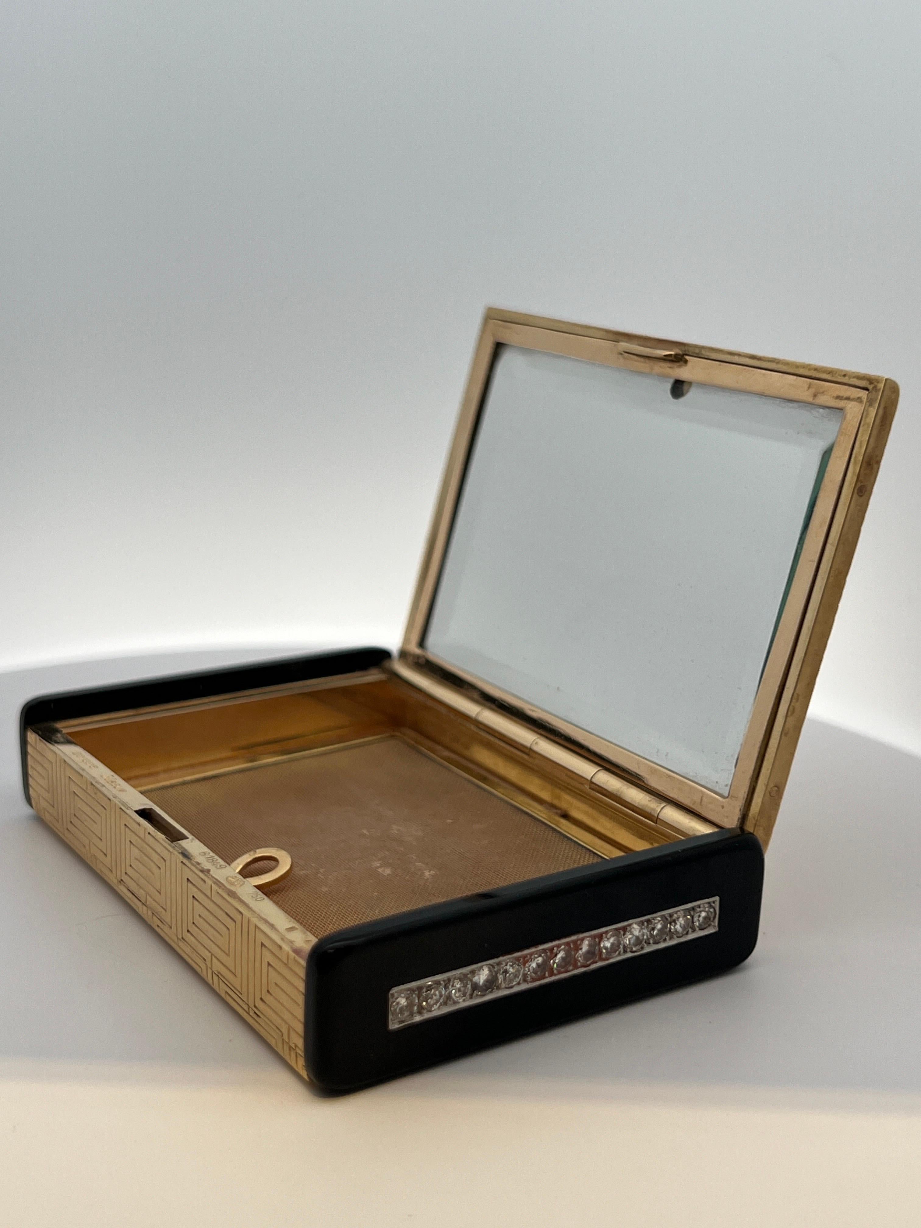 Gubelin Onyx and Diamond Compact Case

A gold compact with a geometric pattern, with onyx sides set with 26 round cut diamonds. The compact opens to a mirror and powder compartment.

Approximate Measurements:  3.25