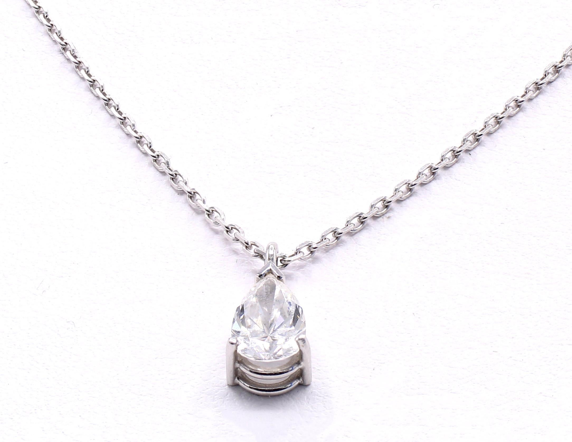 Beautifully handcrafted in 18 karat white gold, by the renown Swiss jeweler Gubelin, this charming and most wearable pendant necklace features a white bright and sparkly pear shape diamond weighing approximately 0.75 carats. The pendant is