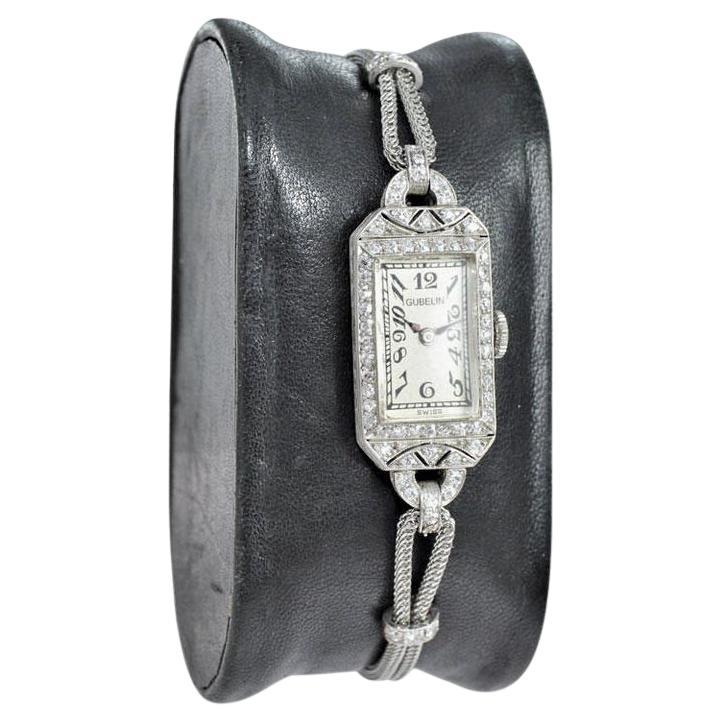 FACTORY / HOUSE: Gubelin Jewelers
STYLE / REFERENCE: Art Deco
METAL / MATERIAL: Platinum
DIMENSIONS: Length 36mm X Width 13mm
CIRCA: 1930's
MOVEMENT / CALIBER:  Manual Winding / 18 Jewels 
DIAL / HANDS: Original Silver Enamel Print
ATTACHMENT /