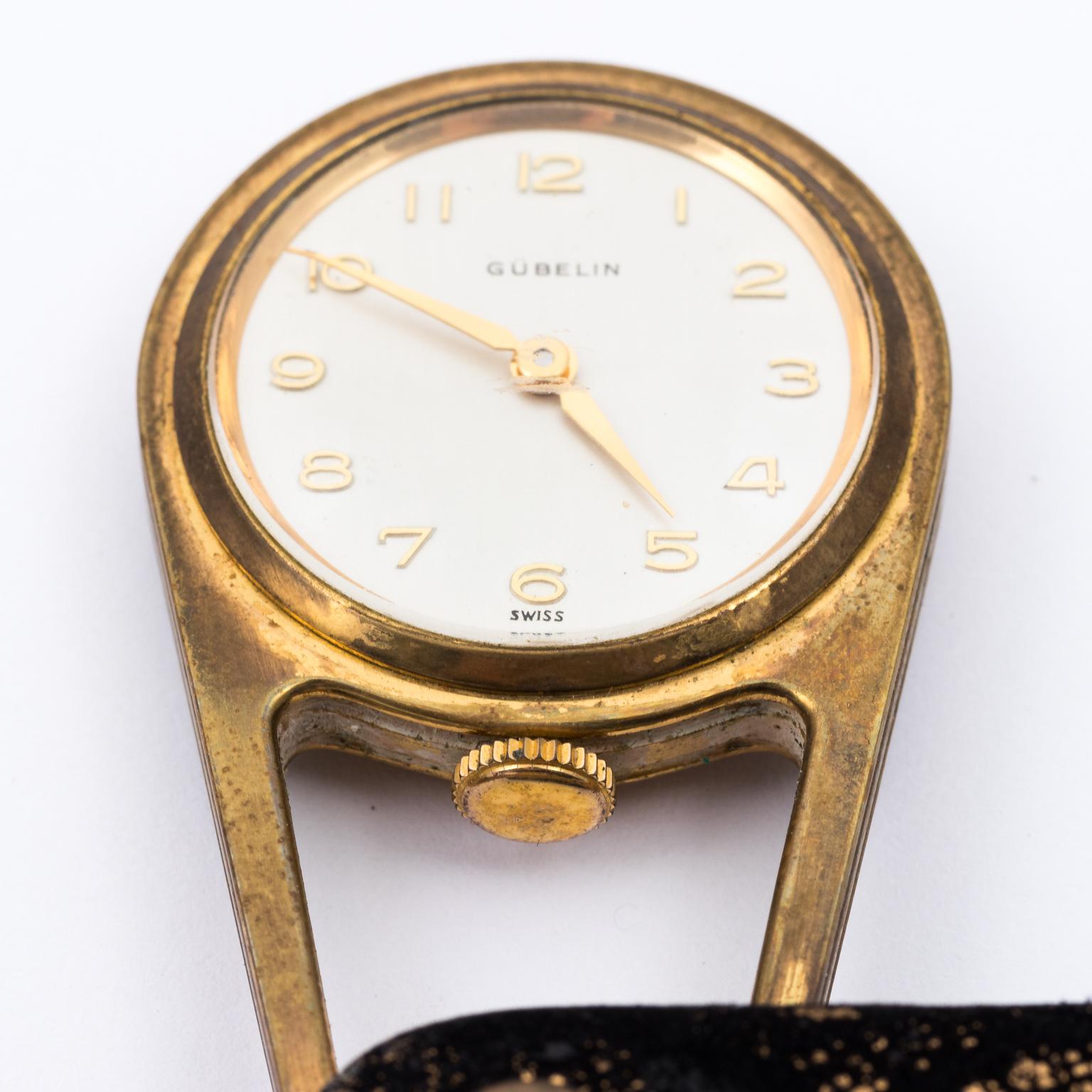 Circa early 20th century rare Gubelin Fils Ladies Switch purse watch in working condition. The brass is covers with a black Silk lace fabric and features a decorative tassel. Weight 70.8
