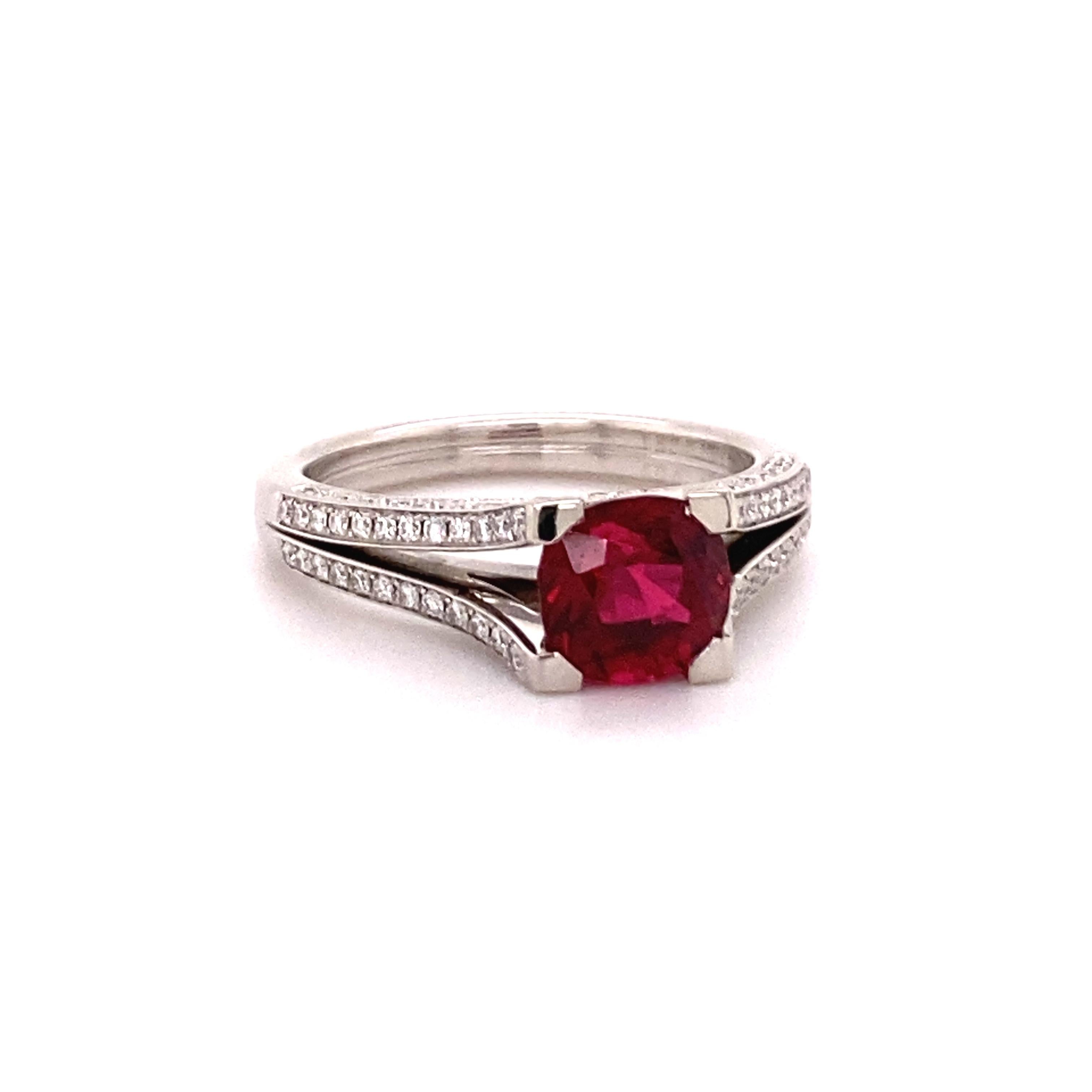 Wonderful, vivid red, cushion-cut Spinel weighting 1.64 ct. Fine setting in 18k white gold, decorated with 134 brilliant-cut diamonds of F/G colour and vs clarity totalling 0.44 ct. Designed as light, angular channels crossing at the bridge of the