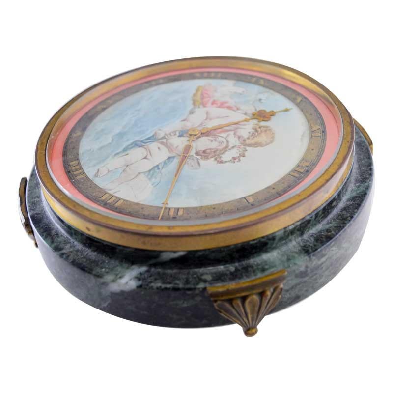 Gubelin Stone and Metal Art Deco Table Clock with Cherubic Hand Made Dial 1930's Unisexe en vente