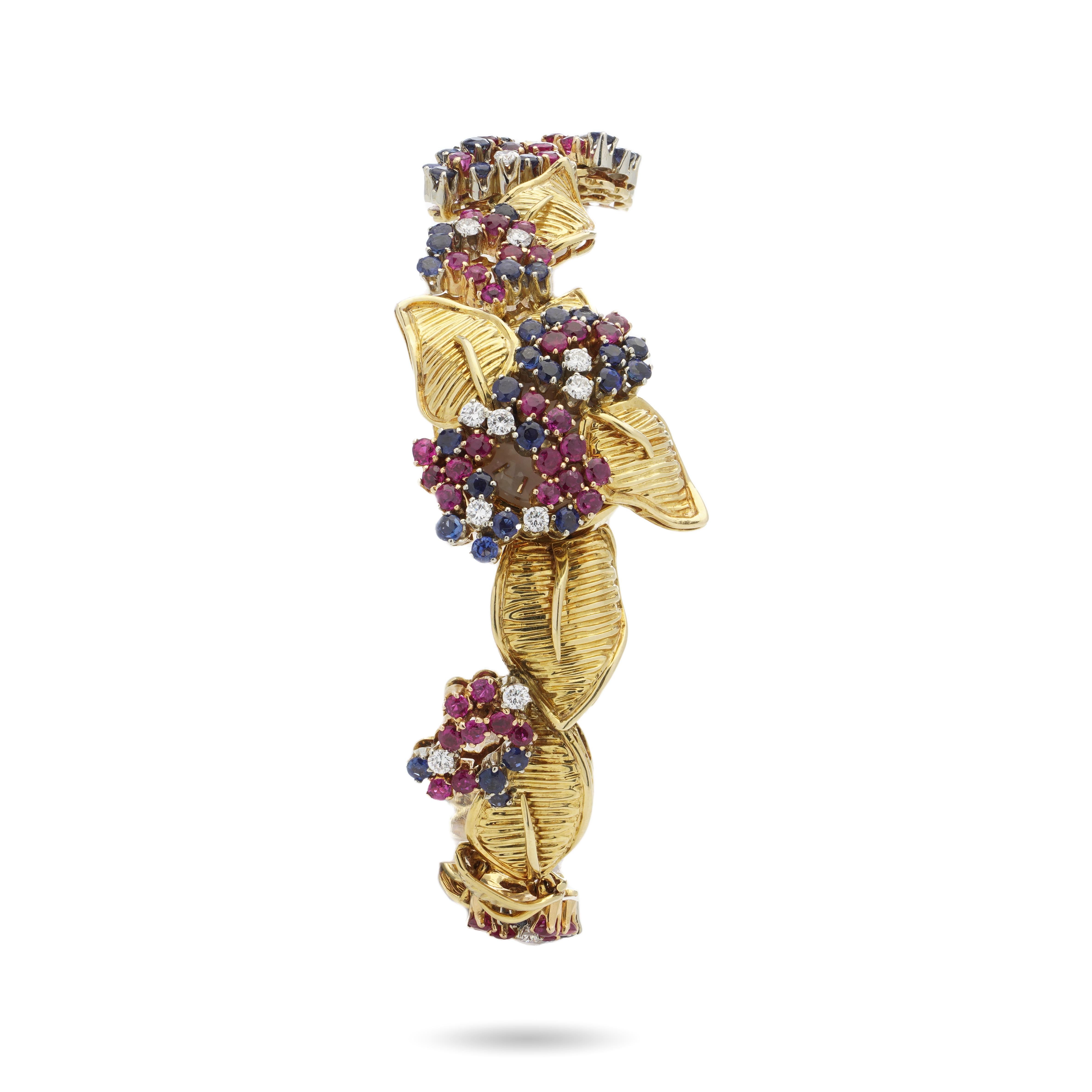 Gübelin vintage 18kt. yellow gold Sapphire, Ruby & Diamond bracelet watch.
Made in Switzerland, Circa 1960's

This breathtaking watch which doubles as a bracelet when the case cover is closed is embellished with a stunning and intricate setting of