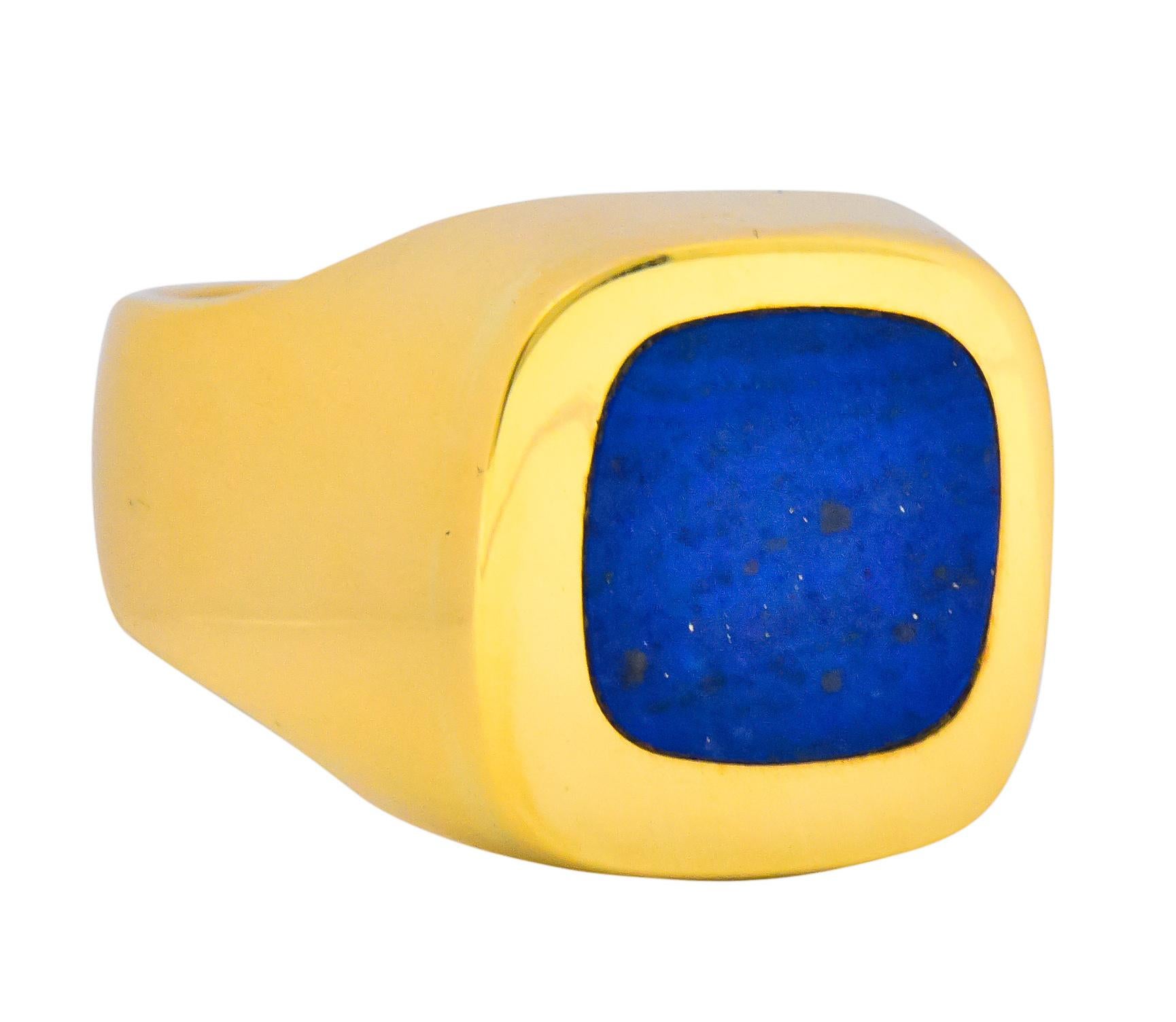 Rounded square lapis slice measuring approximately 12.0 mm, dark ultramarine blue with very little gold pyrite flecking, excellent polish

Flush set into face of rounded square highly polished gold ring

Maker's mark for Gübelin

Stamped with