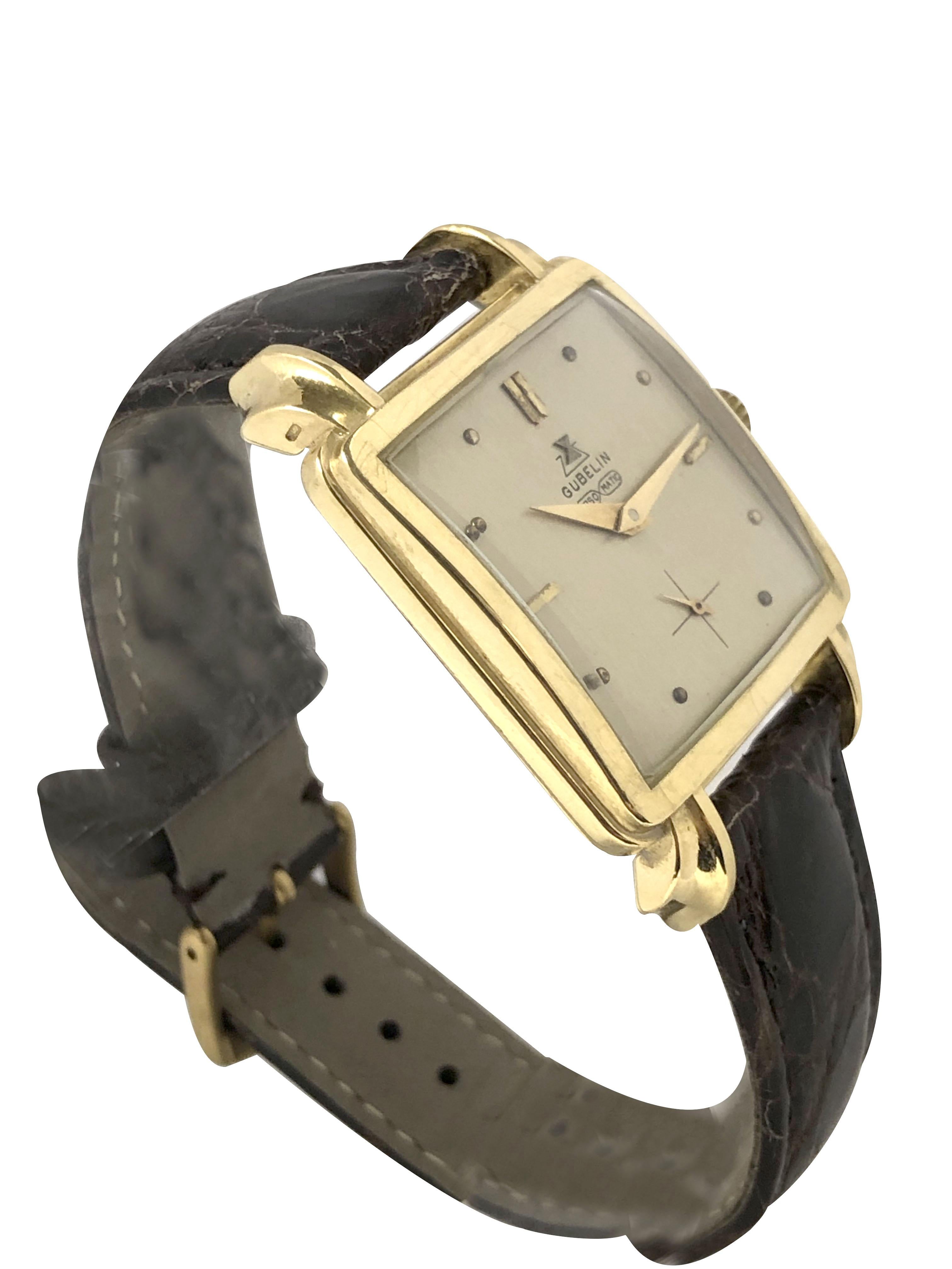Circa 1940s Gubelin Gents Wrist watch, 45 M.M. Lug end to end X 31 M.M. 2 Piece 18K Yellow Gold stepped case with Fancy Flared Lugs. 17 Jewel Mechanical, Manual wind Nickle Lever movement. Silver Satin Dial with raised Gold markers and a sub seconds