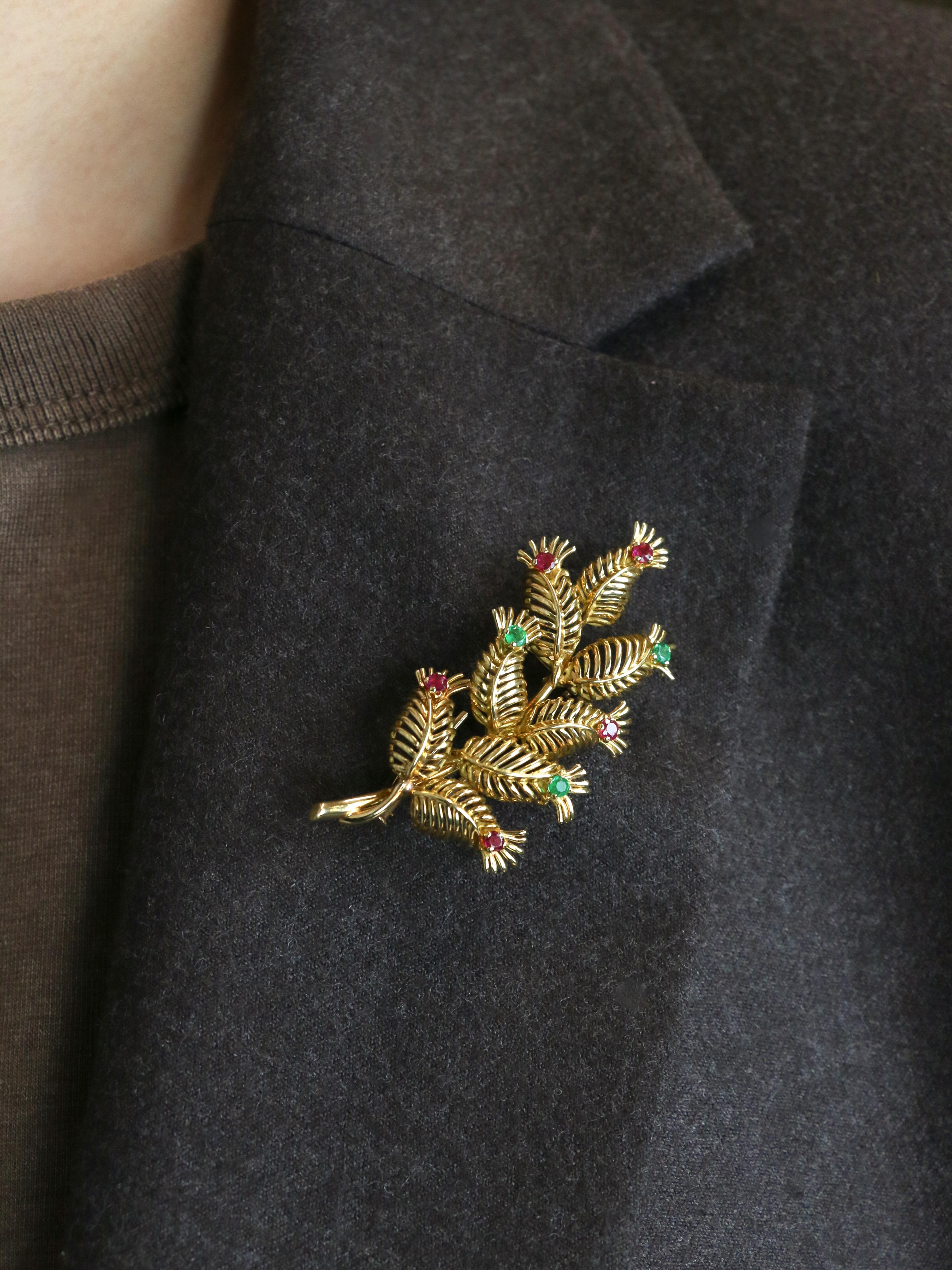 Broche Vintage en or jaune avec rubis et émeraudes - GÜBELIN

Broche en or jaune 18 carats (750/1000) représentant une grappe de feuilles en fil d'or délicat, chacune ornée d'un rubis ou d'une émeraude. Un bel exemple de l'artisanat suisse des
