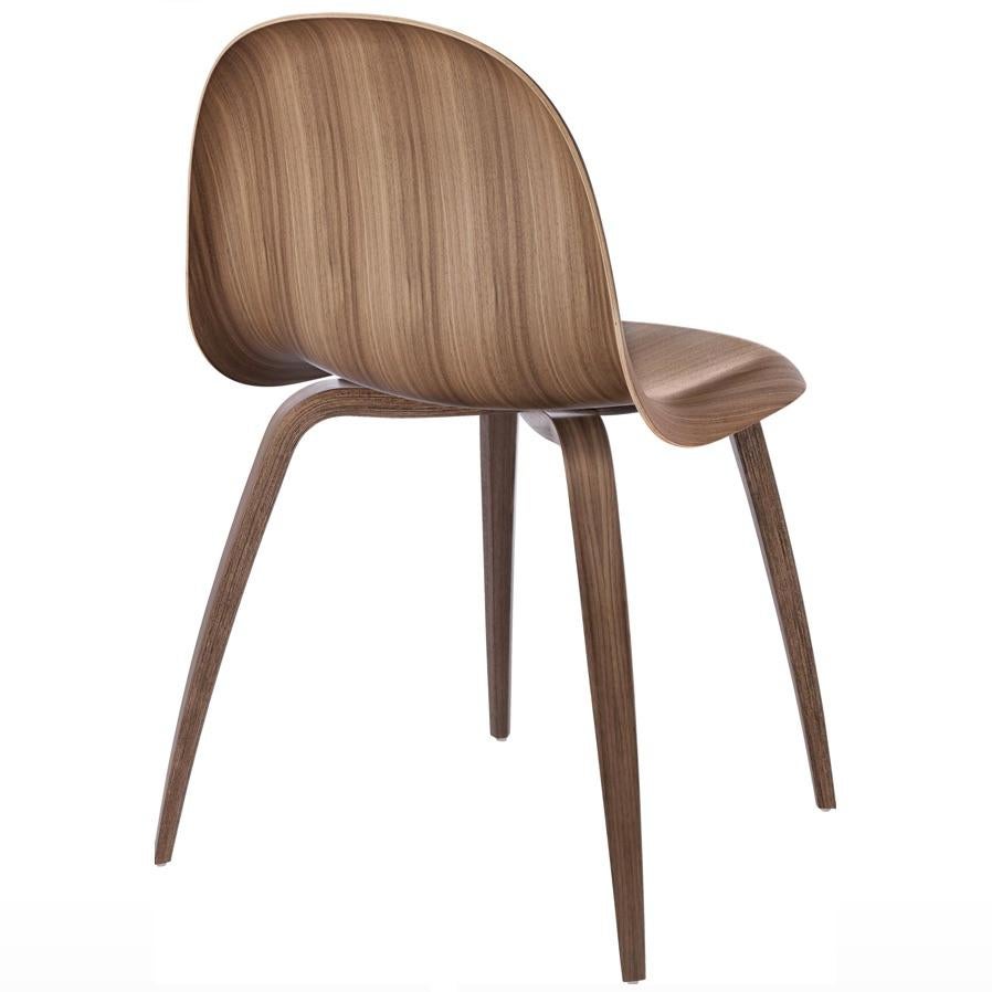 Gubi 3D dining chair in American Walnut by Komplot. Designed in 2003 by Boris Berlin and Poul Christiansen of Komplot Design, the Gubi Chair is the first furniture design to be based on the innovative technique of three-dimensional veneer molding.