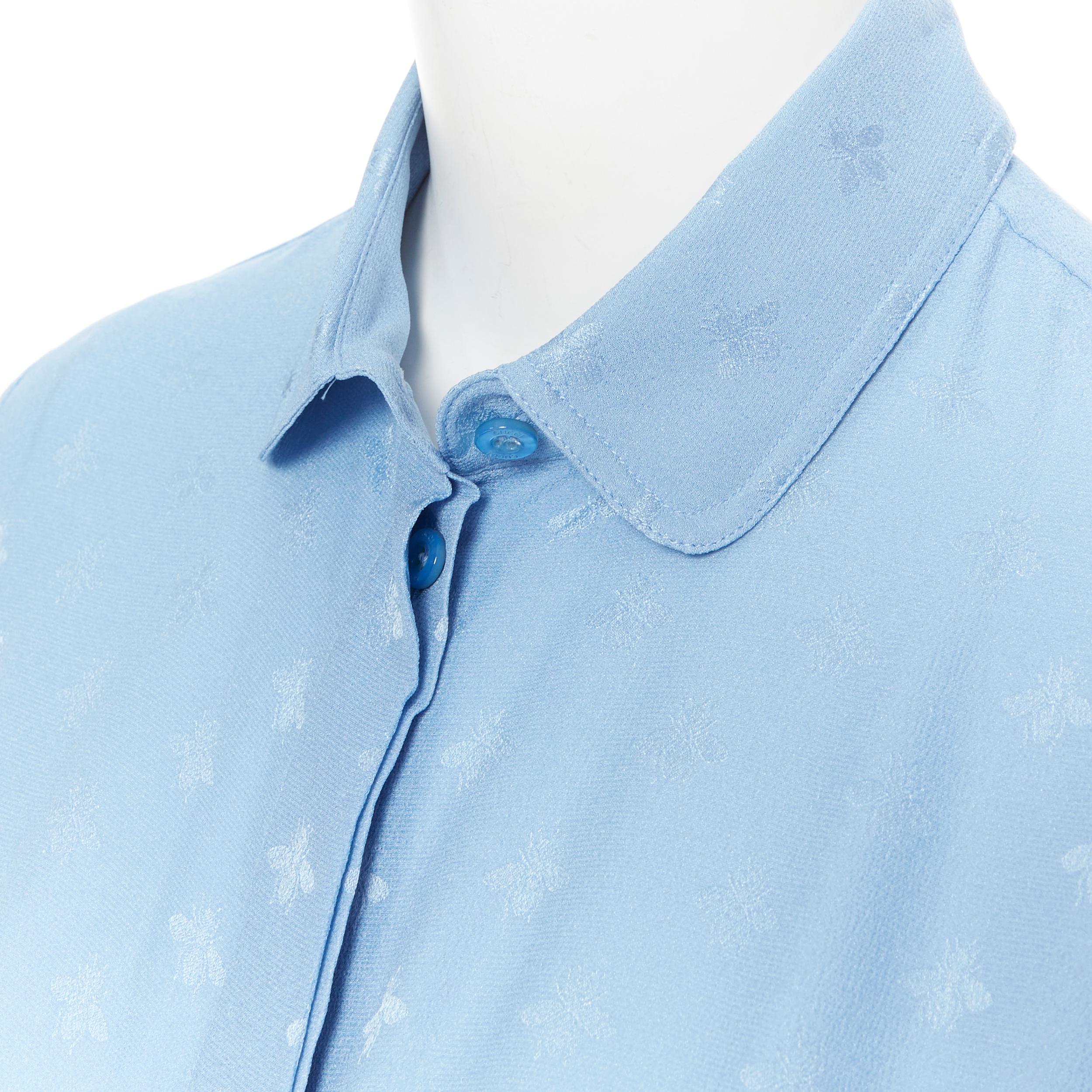 GUCCI 100% Cambridge silk sky blue bee jacquard club collar shirt IT38 XS 
Reference: LNKO/A01271 
Brand: Gucci 
Material: Silk 
Color: Blue 
Pattern: Other 
Closure: Button 
Extra Detail: Concealed button front closure. Dual slit on side at hem.