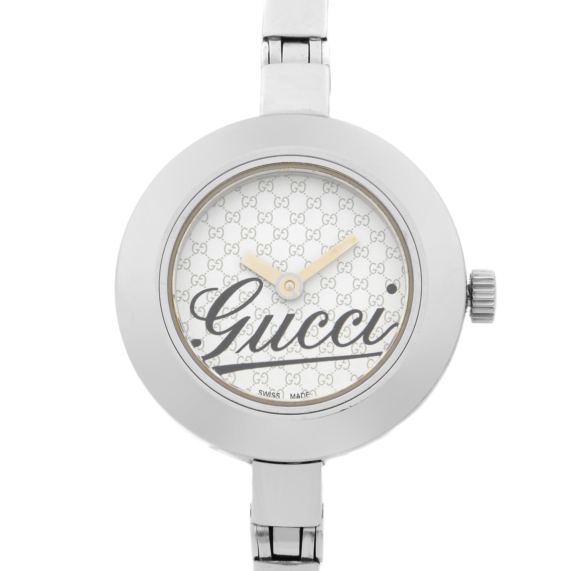 This pre-owned Gucci 105 G YA105528  is a beautiful Ladie's timepiece that is powered by quartz (battery) movement which is cased in a stainless steel case. It has a round shape face, no features dial, and has hand unspecified style markers. It is