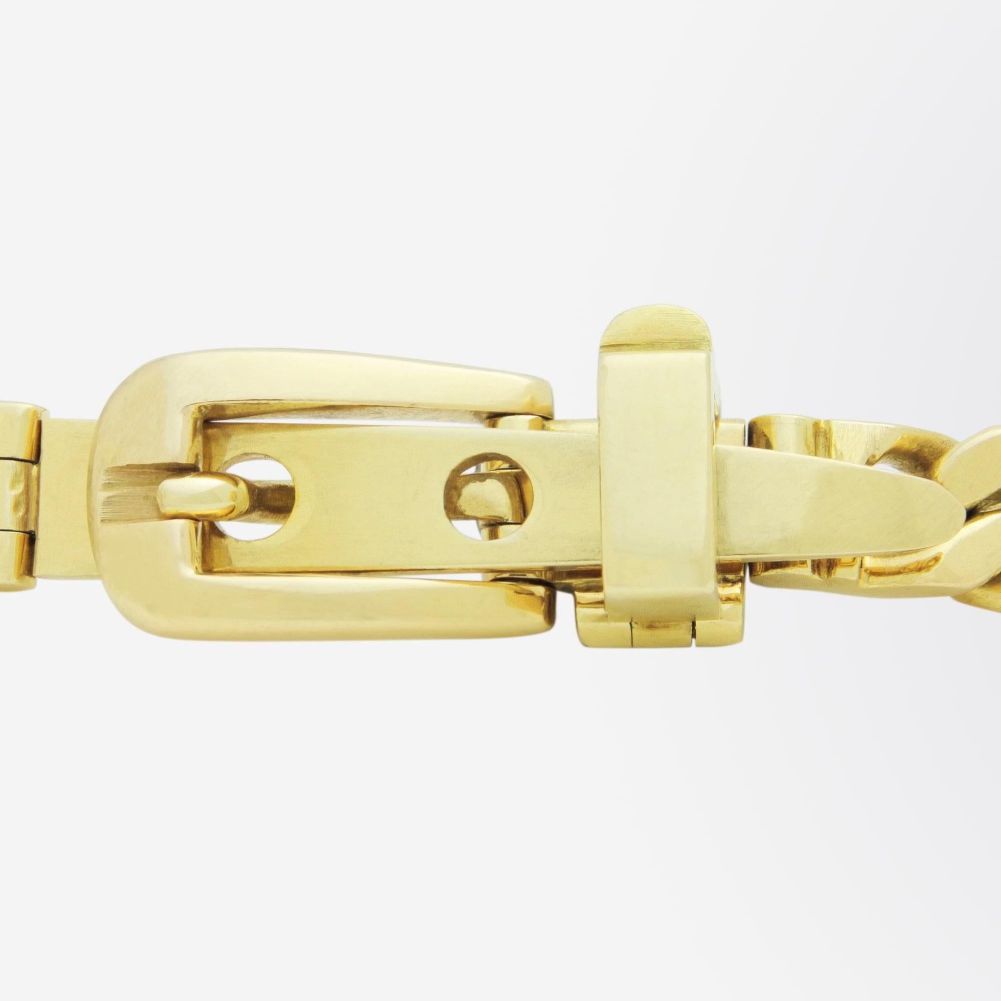 A heavy 18 karat yellow gold curb bracelet with a belt buckle style clasp. The piece which is beautifully made, is Italian in origin and is marked 'Gucci', very likely from the 1970s. Gucci who are known for their shoes, clothes and leather goods