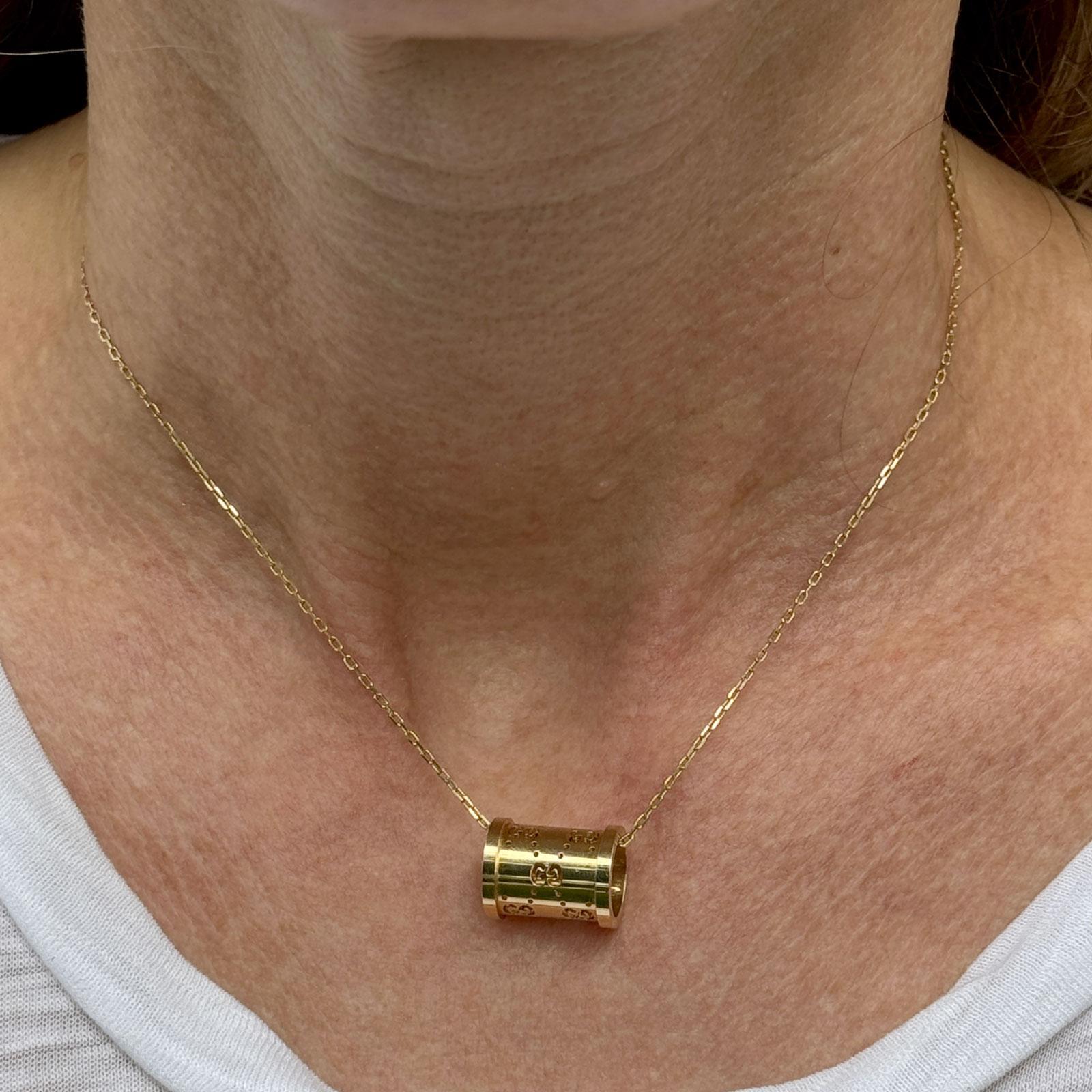 18K yellow gold Gucci Icon Twirl Necklace featuring a polished 10 x 15 mm barrel pendant engraved with the iconic Gucci logo. The adjustable chain can be worn at 15, 15.5, or 16.5 inches. Hallmarked and signed Gucci, made in Italy. Weight: 7.5 grams.