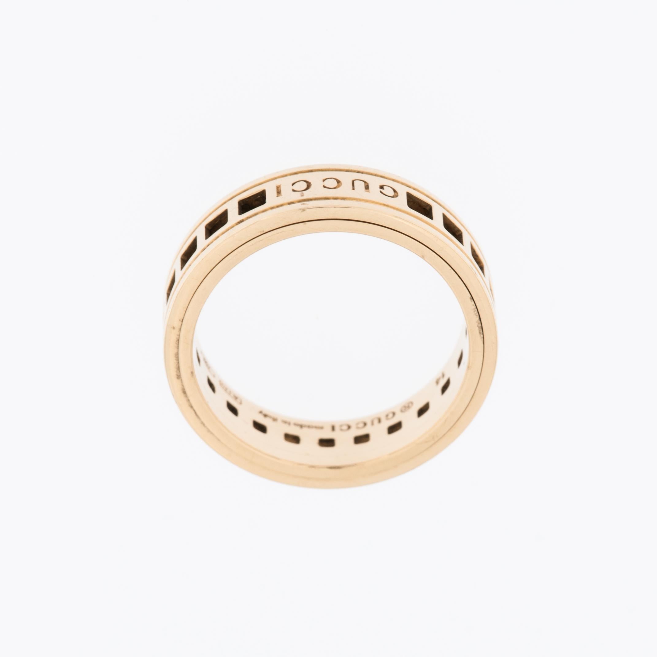 The Gucci 18-karat Yellow Gold Scroll Band Ring is a distinctive and luxurious piece of jewelry that reflects the iconic style and craftsmanship of the renowned Italian fashion house. This ring captures the essence of Gucci's design philosophy,