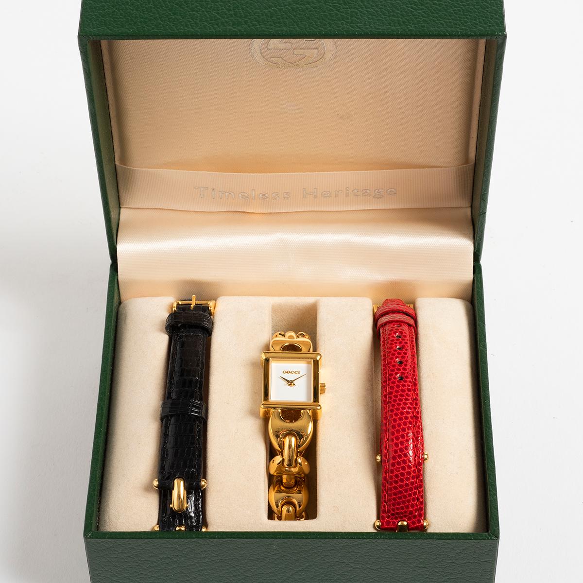 Our Gucci 1800L ladies dress watch features a gold plated bracelet and 16mm case with white dial. The bracelet can be swapped using an ingenious twist and push/pull system for the red leather or black leather straps (included) with original gold
