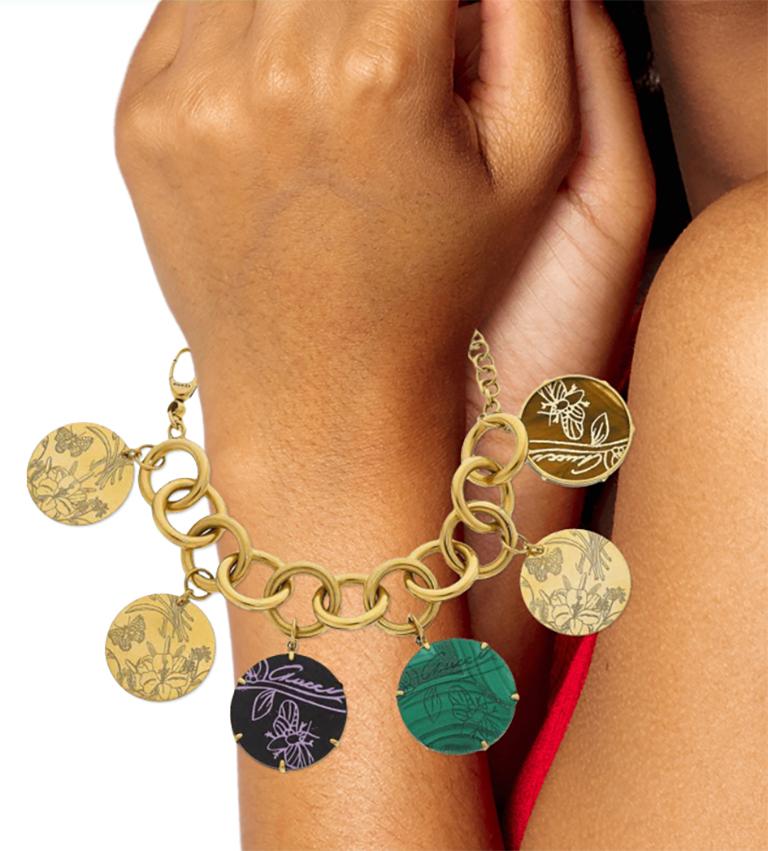 Gucci 18k Gold Multi-Stone Bracelet
Charm bracelet, Butterfly, Flowers set in Round malachite, tiger's-eye, black hardstone tablets
Marked Gucci made in Italy 17. Gross Weight: 59.6 dwts
Charm Diameter: 1-1/4 inches
Bracelet Length: 7-1/2 inches