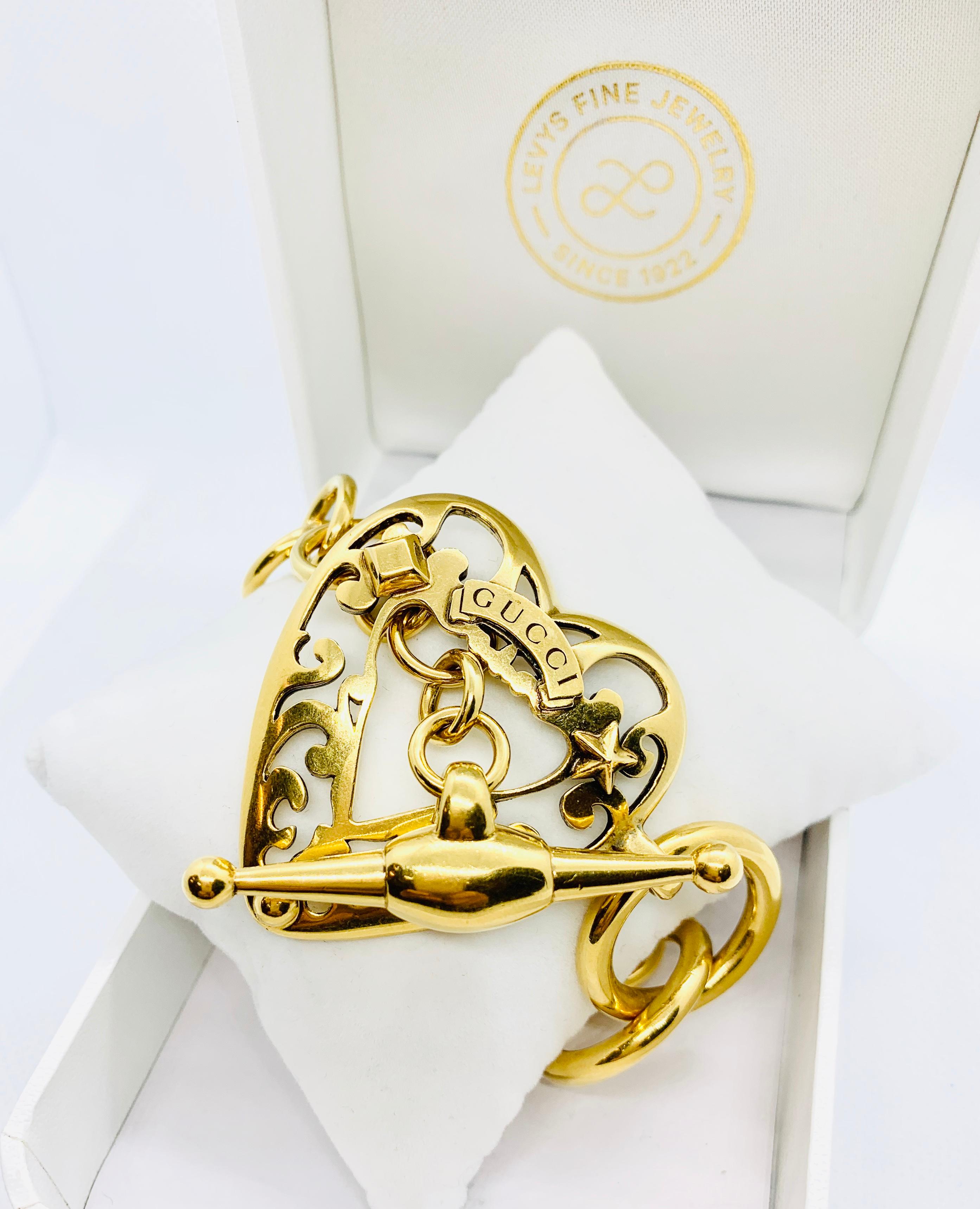 Gorgeous Gucci link bracelet! Made in 18K Yellow Gold, the links range from 1/2 inch, 3/4 inch & 1 inch in diameter. The toggle measures 2 inches long. The heart center piece measures 2 inches by 1.5 inches. The pieces is seven inches long and