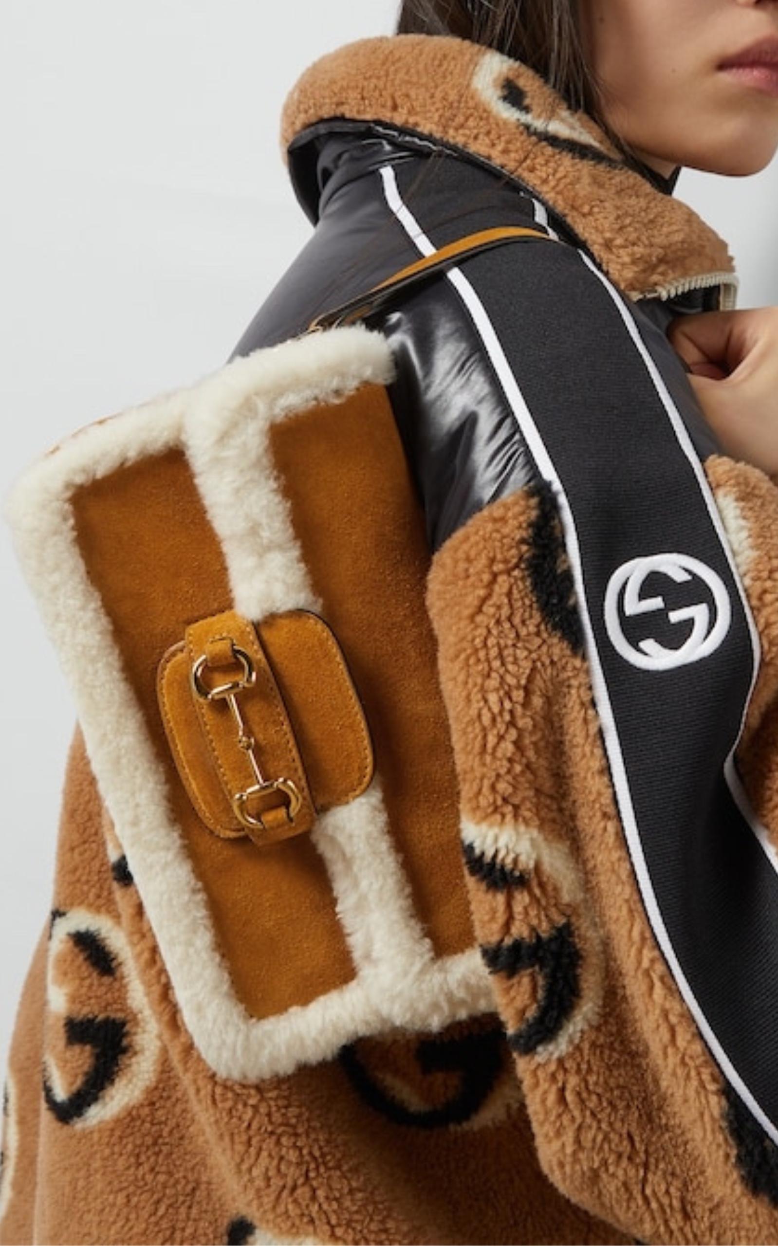 This mini Horsebit 1955 Shearling-Trimmed Suede Tote Bag has a structured shape defined by shearling trim leather and a beige suede body.
The flap closure is complete with Horsebit gold hardware
Light brown suede
Gold-toned hardware
Strap drop with