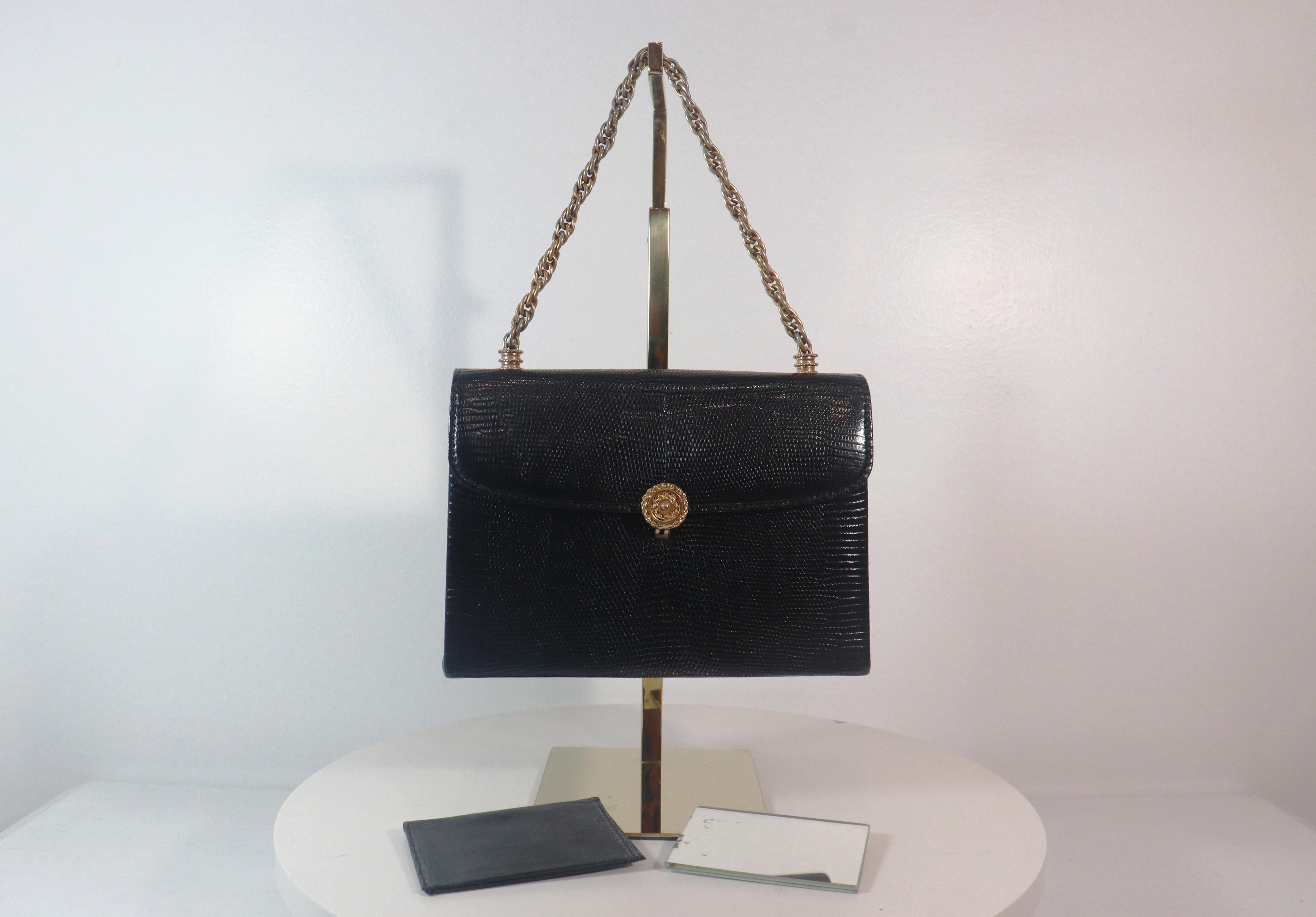 Gucci 1960s black leather lizard handbag with mini wallet and mini rectangular mirror.  

This handbag is in 'LIKE NEW' condition. There are significant flaws or wear areas to consider with this lovely handbag. It has been very gently used and