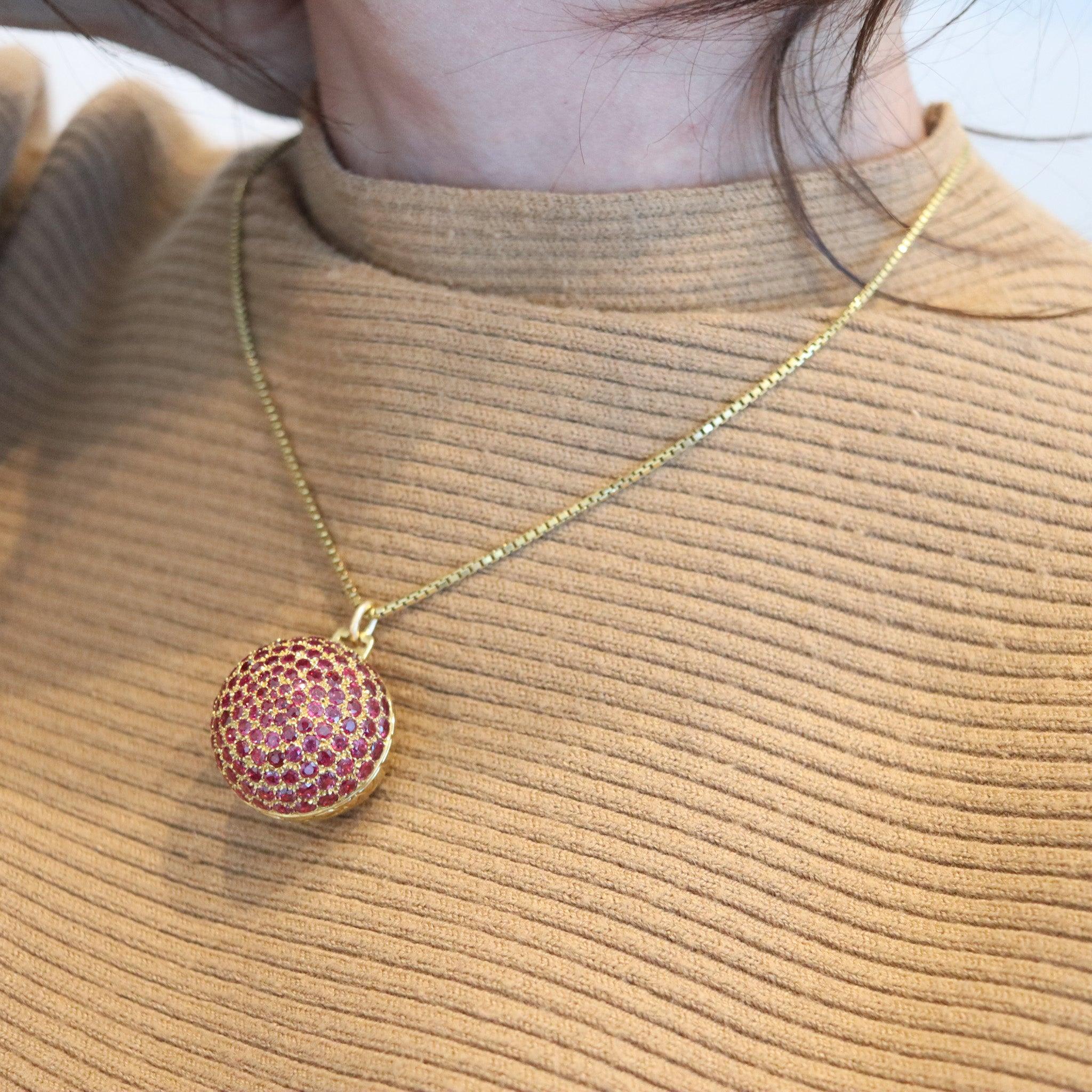A rare secret-box ball pendant designed by Gucci.

This is a very rare vintage secret-box ball pendant created in Milano Italy by the house of Gucci, back in 1970. The box-pendant has been designed as a sculptural jeweled sphere with imprint