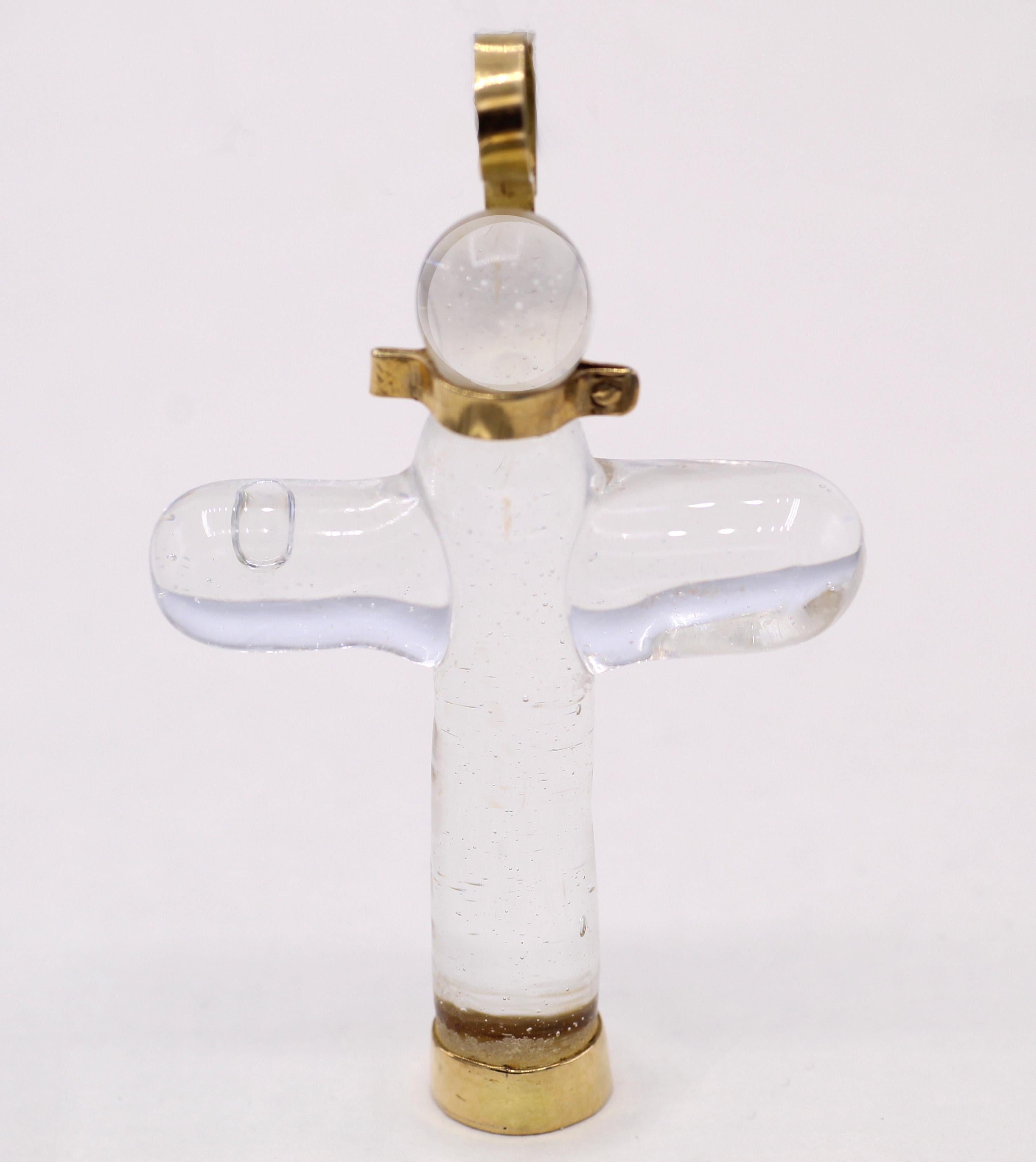Chic and style which the iconic designer Gucci was known for are exhibited in this fashionable and most wearable cross pendant. The cross has been cut and polished out of blown crystal with and abstract gold collar at the top connected to a golden