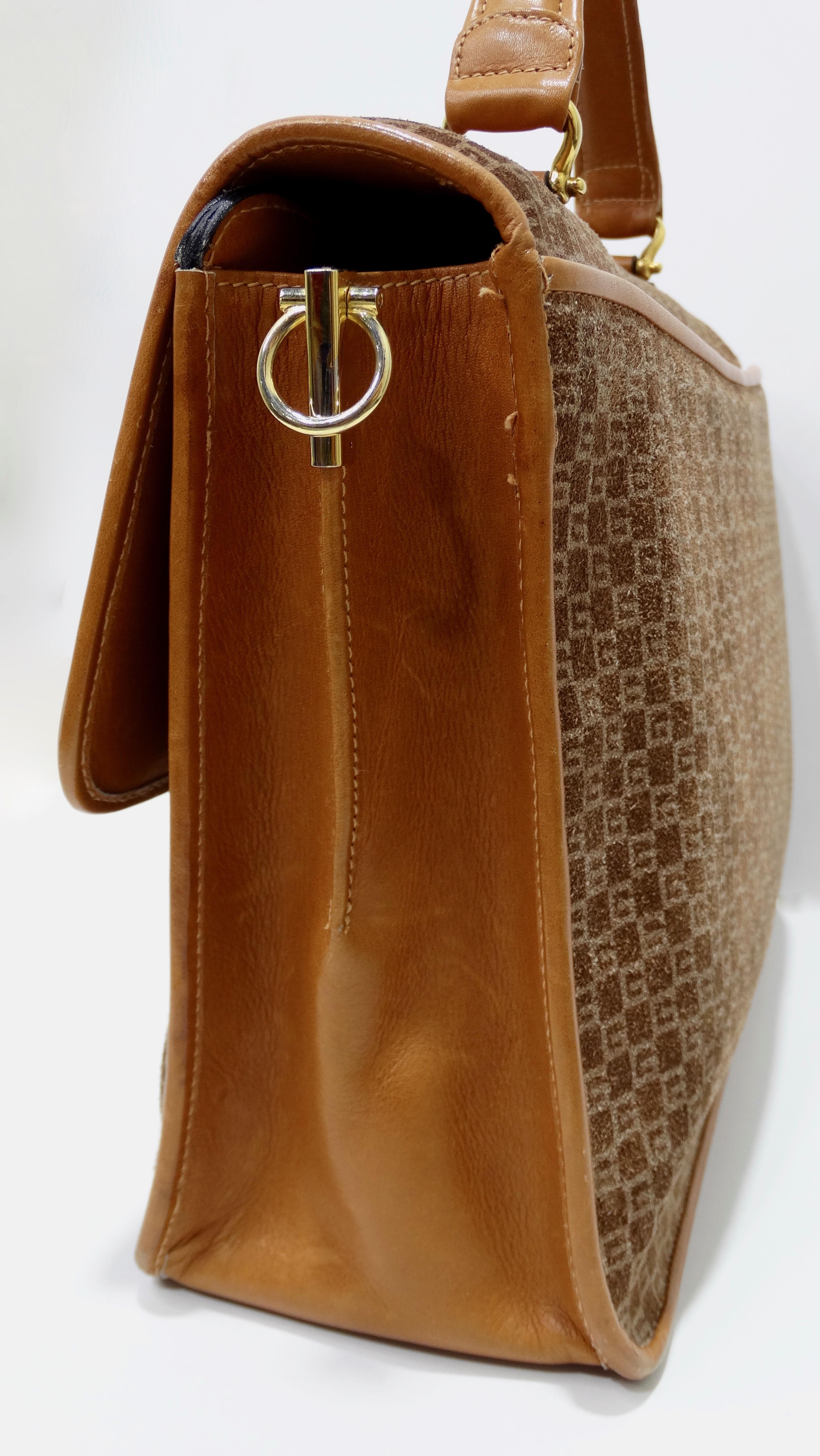 Snag yourself the ultimate Gucci bag! Circa 1970s, this satchel features brown and tan monogram suede, gold plated hardware, single flat top handle, patch pocket on the back face, tan leather piping, an optional flat shoulder strap, and a pull-