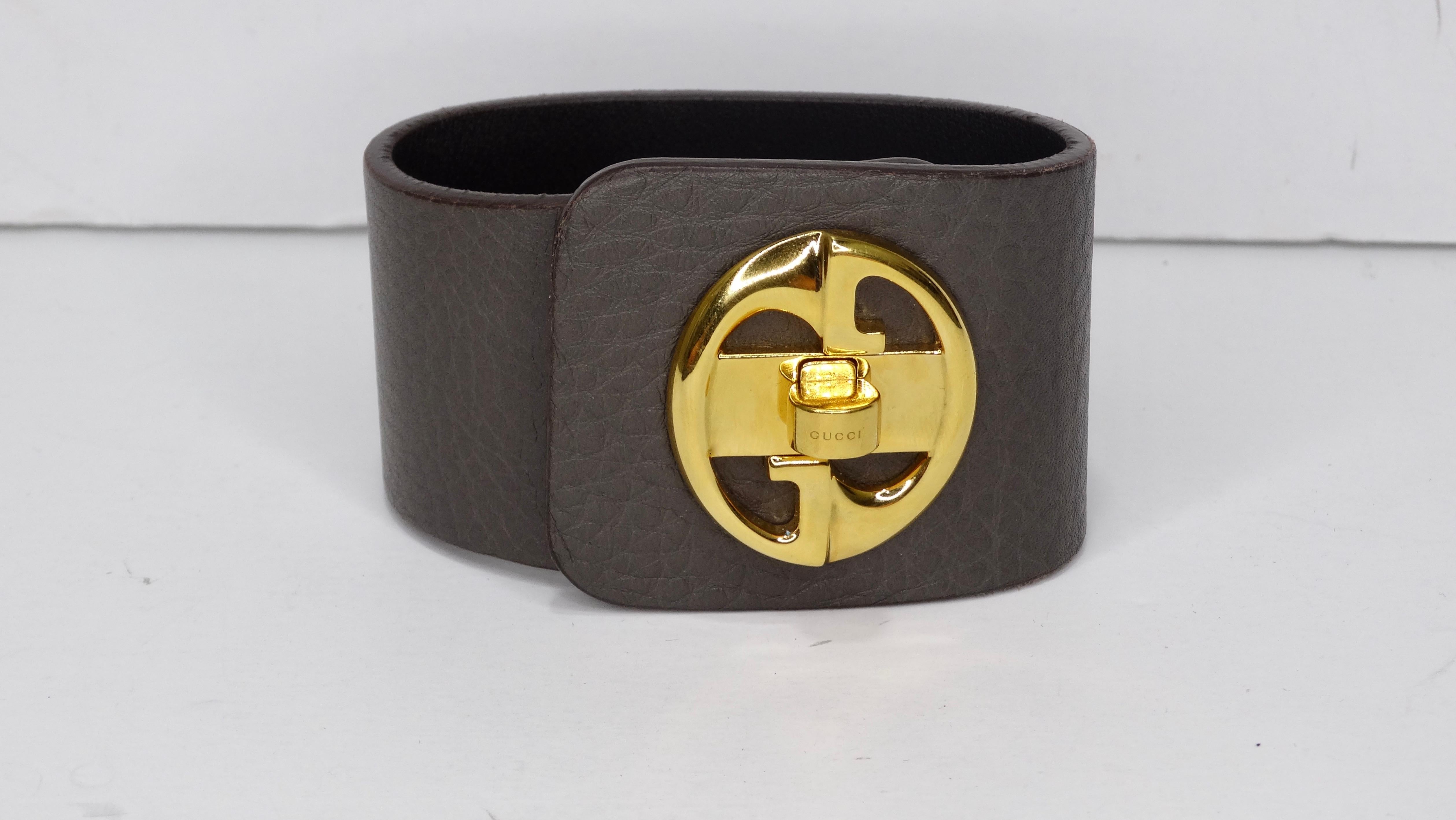 Get this Gucci before it's too late! Circa 1973, this grey leather cuff features a gold toned vintage Gucci logo with a turn lock closure. Stamped on the inside made in Italy. Size is 17 in Italian compares to a US 7 -7 1/2. For all the Gucci