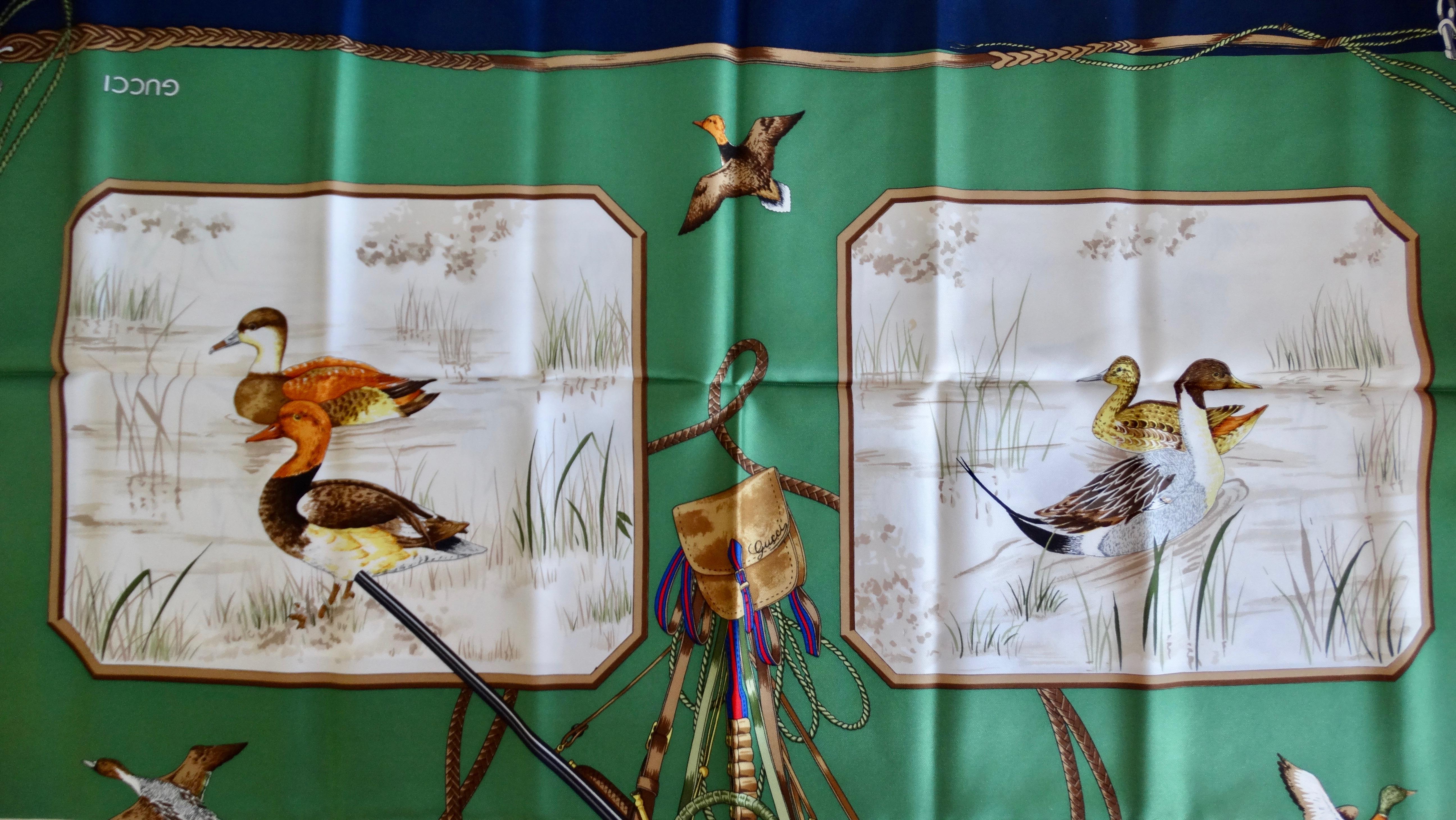 Everyone need a Gucci scarf in their wardrobe! Circa 1980s, this gorgeous Gucci silk scarf features a duck hunting motif. Motif includes 4 duck scenes, a hunting bag and scattered flying ducks. A green backdrop contrasts against the rich natural