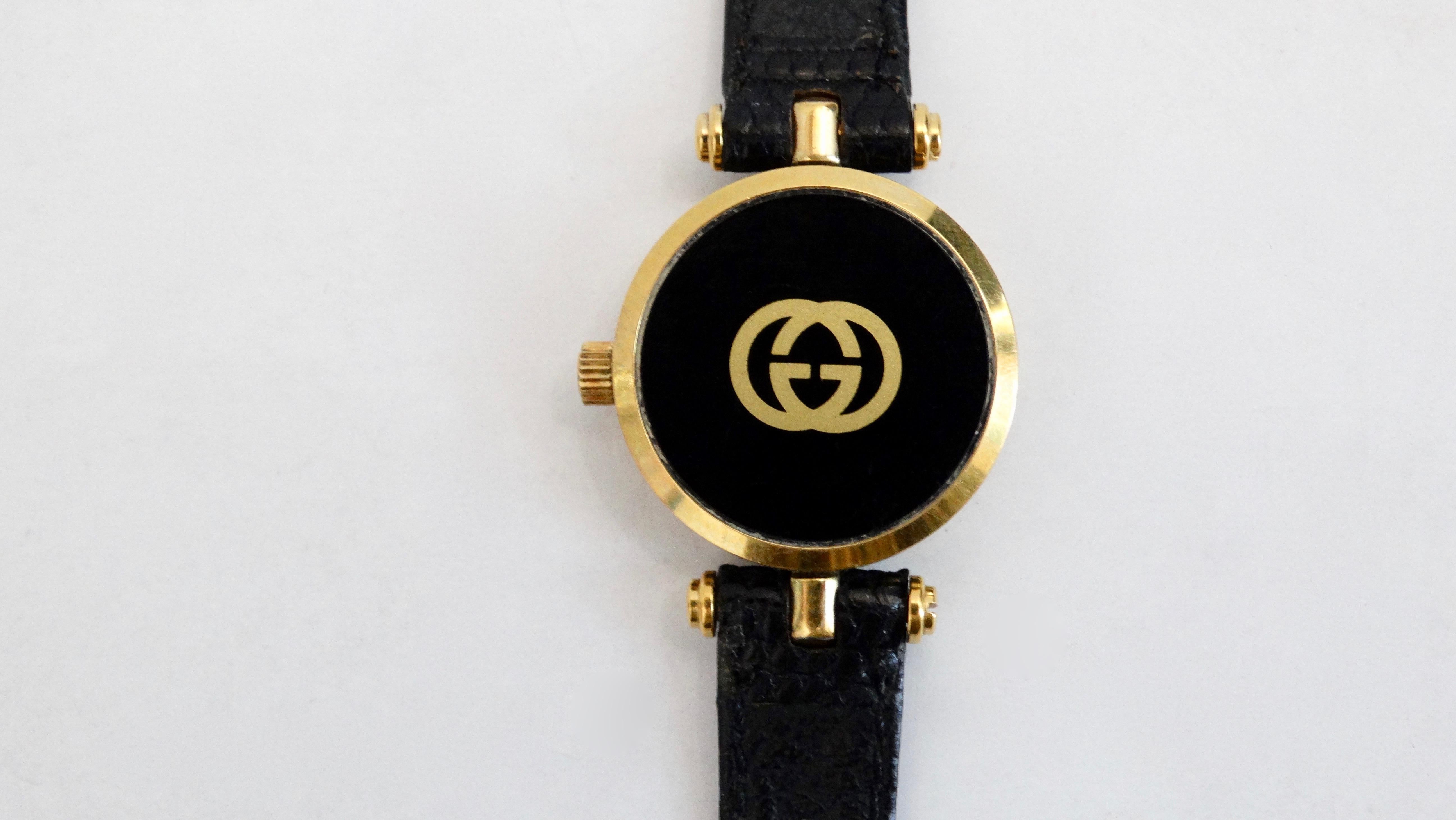 A classic timepiece to complete all your look! Circa 1980s , this watch is features a solid black face with gold roman numerals. Hardware cast in gold metal accented with black enamel stripes on the side. Buckle embossed with the classic GG logo,
