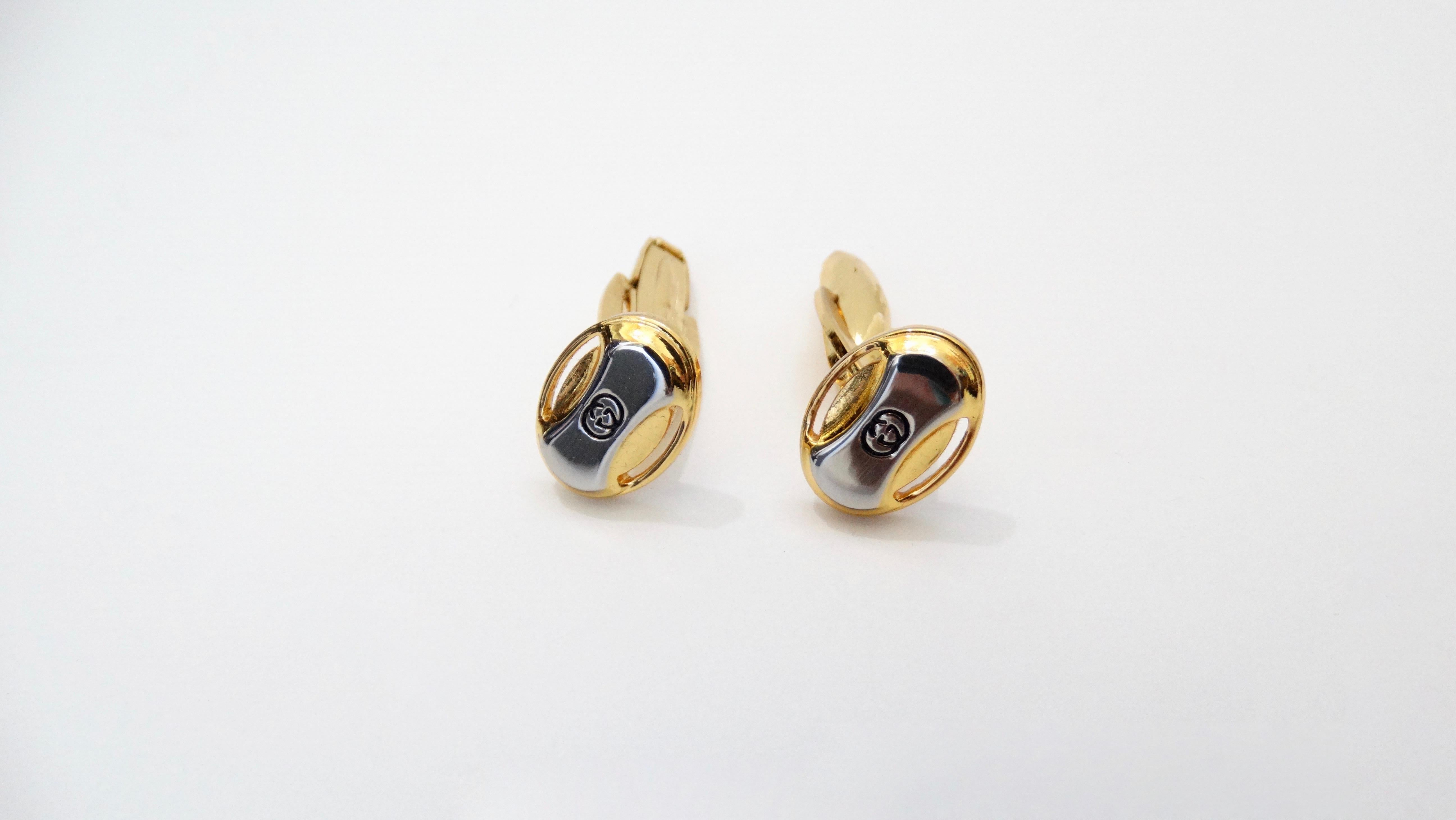Stay in style with this Gucci cufflink and tie clip set! Circa 1980s, these cuff links and tie clip are plated in contrasting silver and gold hardware and feature the signature Gucci logo. Classic and simple, this set is sure to elevate your