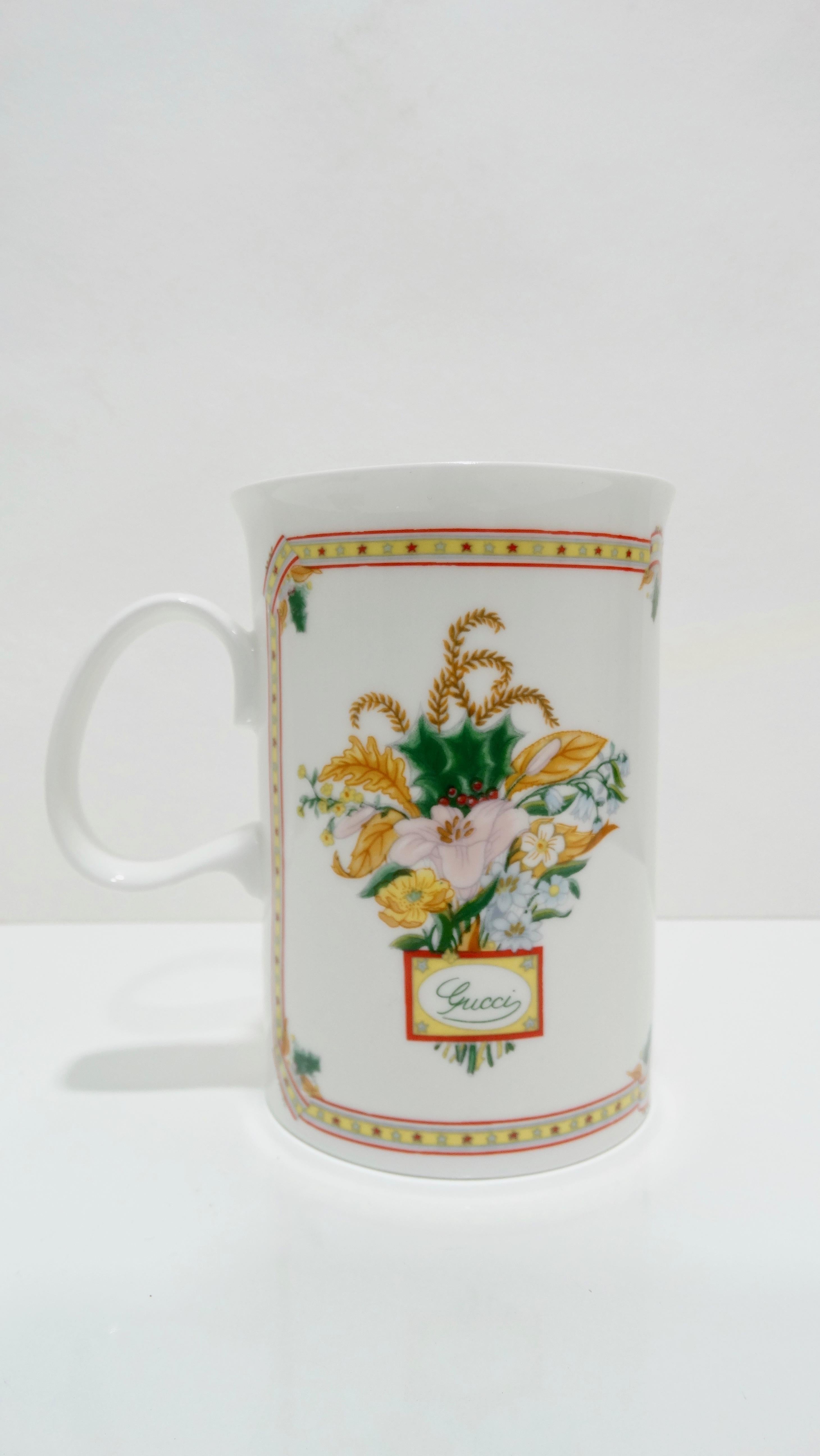 Elevate your dinner setting during the holidays with this set of Gucci mugs! Circa late 1970s/early 1980s, this set includes 6 mugs crafted from fine bone china. Each mug features a dual design with a flora motif on one side and a Christmas motif on