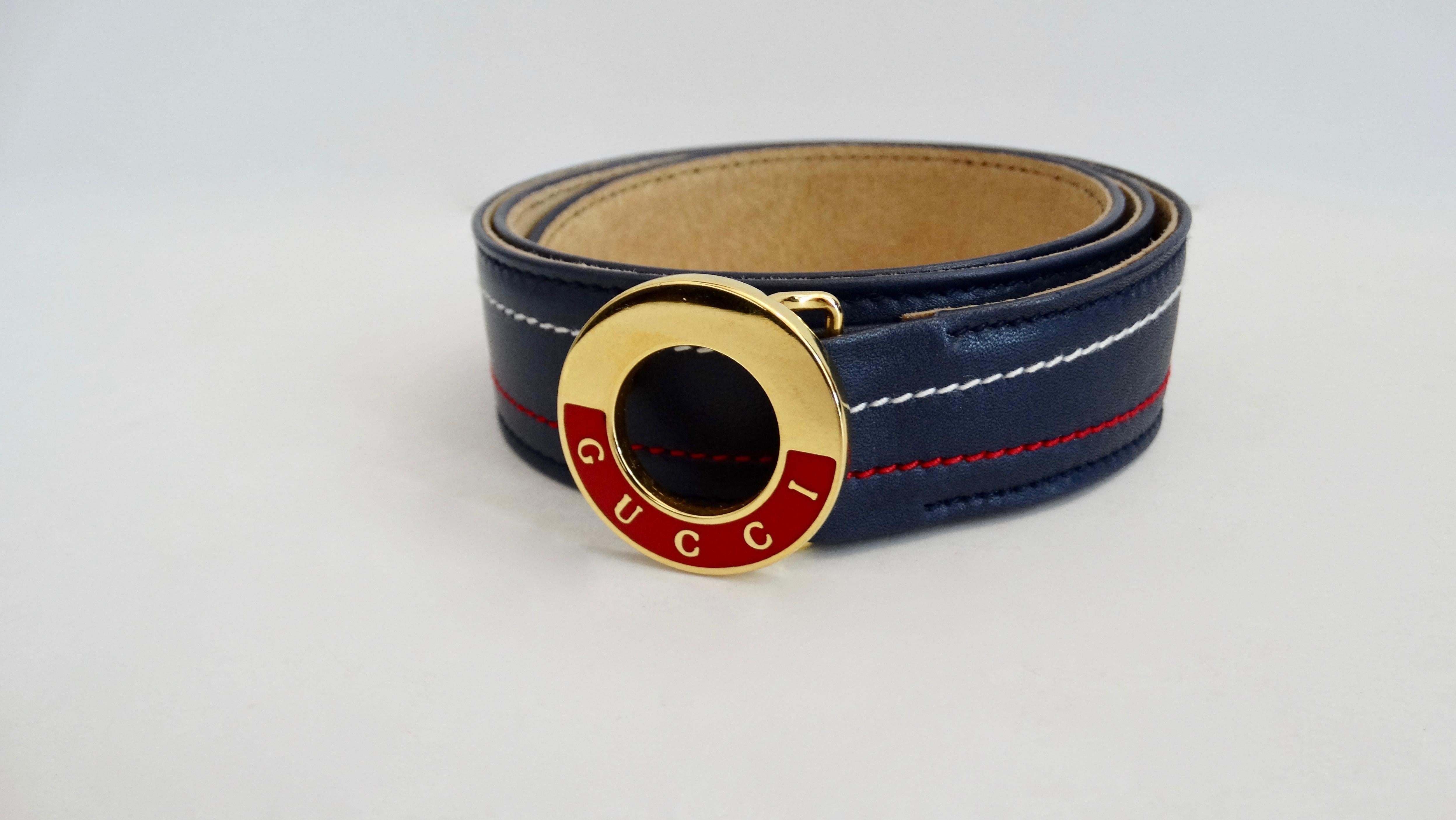 Keep it classic with this Gucci belt! Circa 1980s, this belt is made from navy blue leather and features white and red stitching. Buckle is gold plated with red enamel and is stamped Gucci. Includes 3 peg hole closures. The perfect belt to pair with