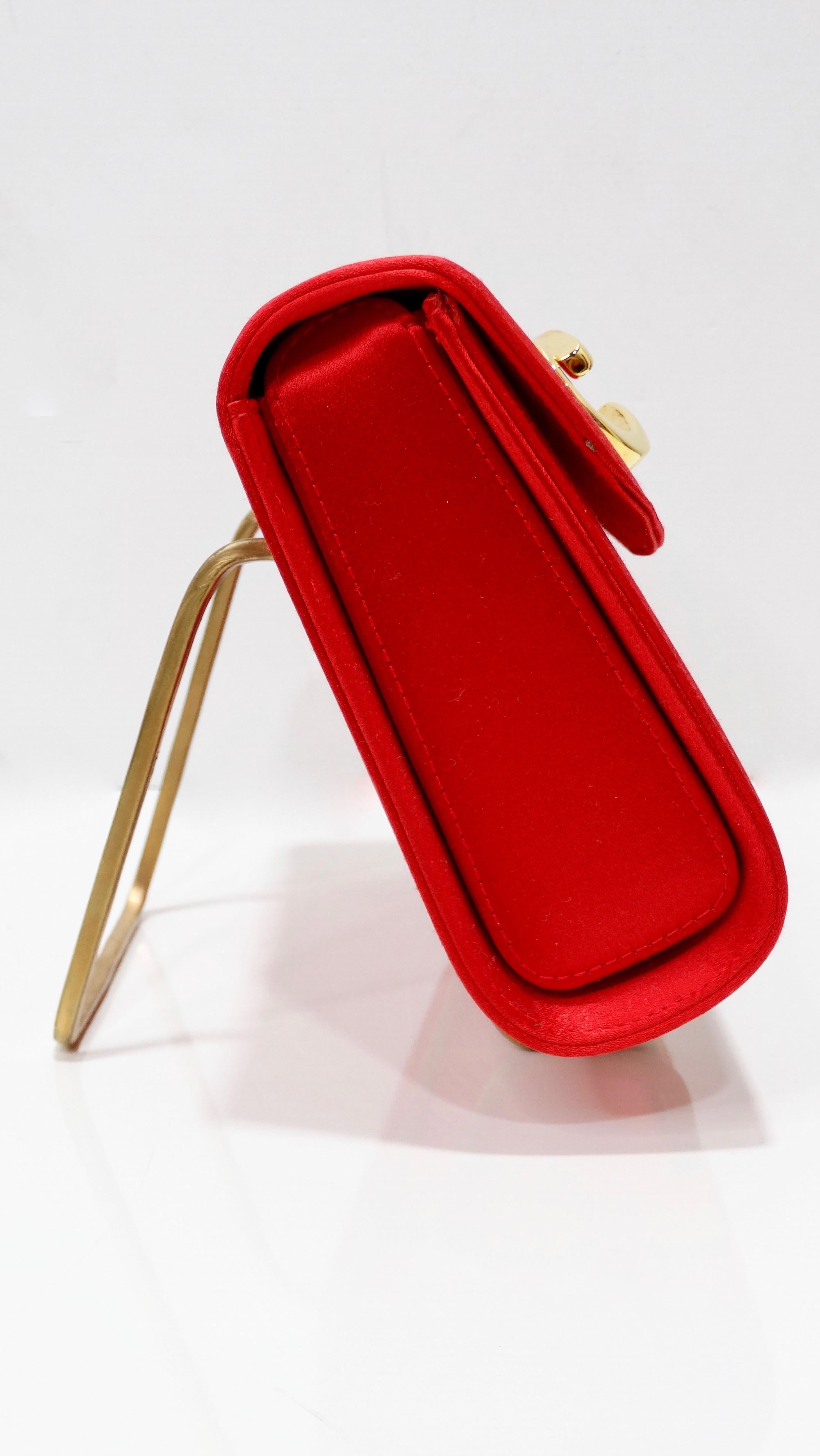 Go into the Gucci archives with this red hot clutch! Circa 1980s, this clutch is made from vibrant red satin and features a vintage take on the Gucci logo on the front face, gold hardware, a removable single red shoulder strap and a magnetic button