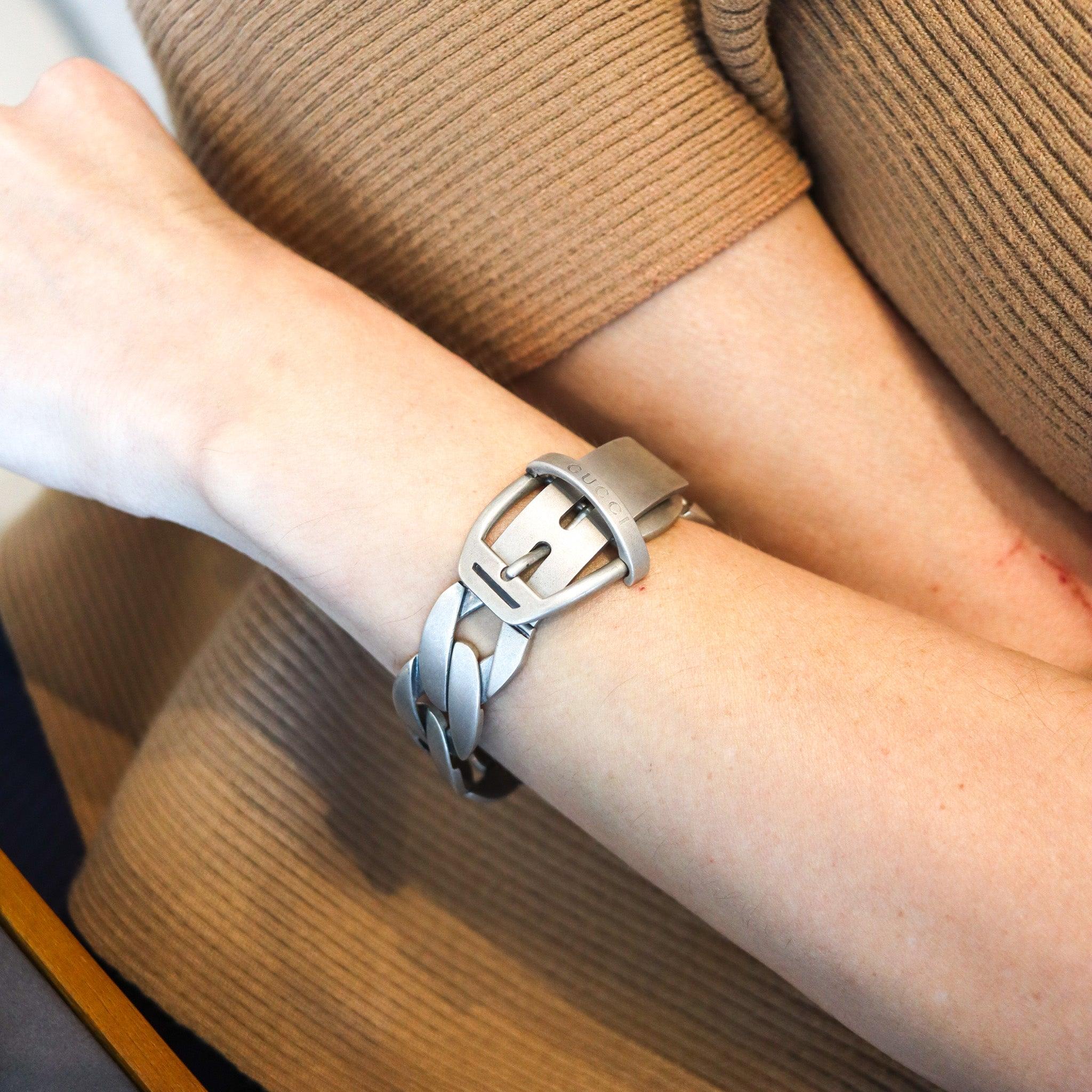 Chained buckle bracelet designed by Gucci.

This is an iconic vintage buckle bracelet created in Florence Italy by the luxury house of Gucci, back in 1990. This buckle bracelet model was crafted in solid .925/,999 sterling silver with brushed