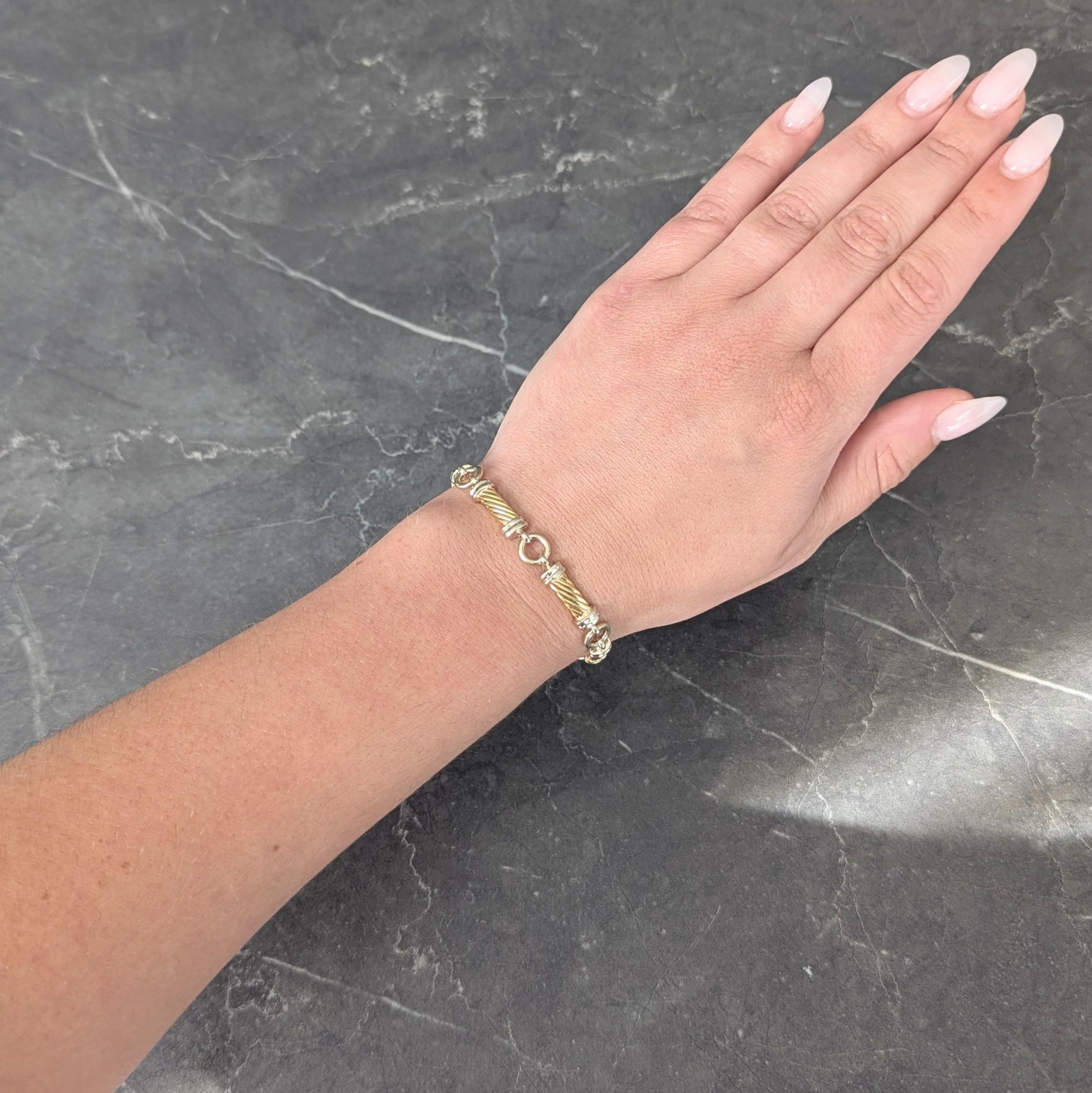 Comprised of yellow gold bar links grooved as twisted columns with white gold terminals
Grooved and connected to white gold circle links
Completed by lobster clasp closure
Stamped for 18 karat gold
Signed for Gucci
Circa: 1990s
Width at Widest: 5/16