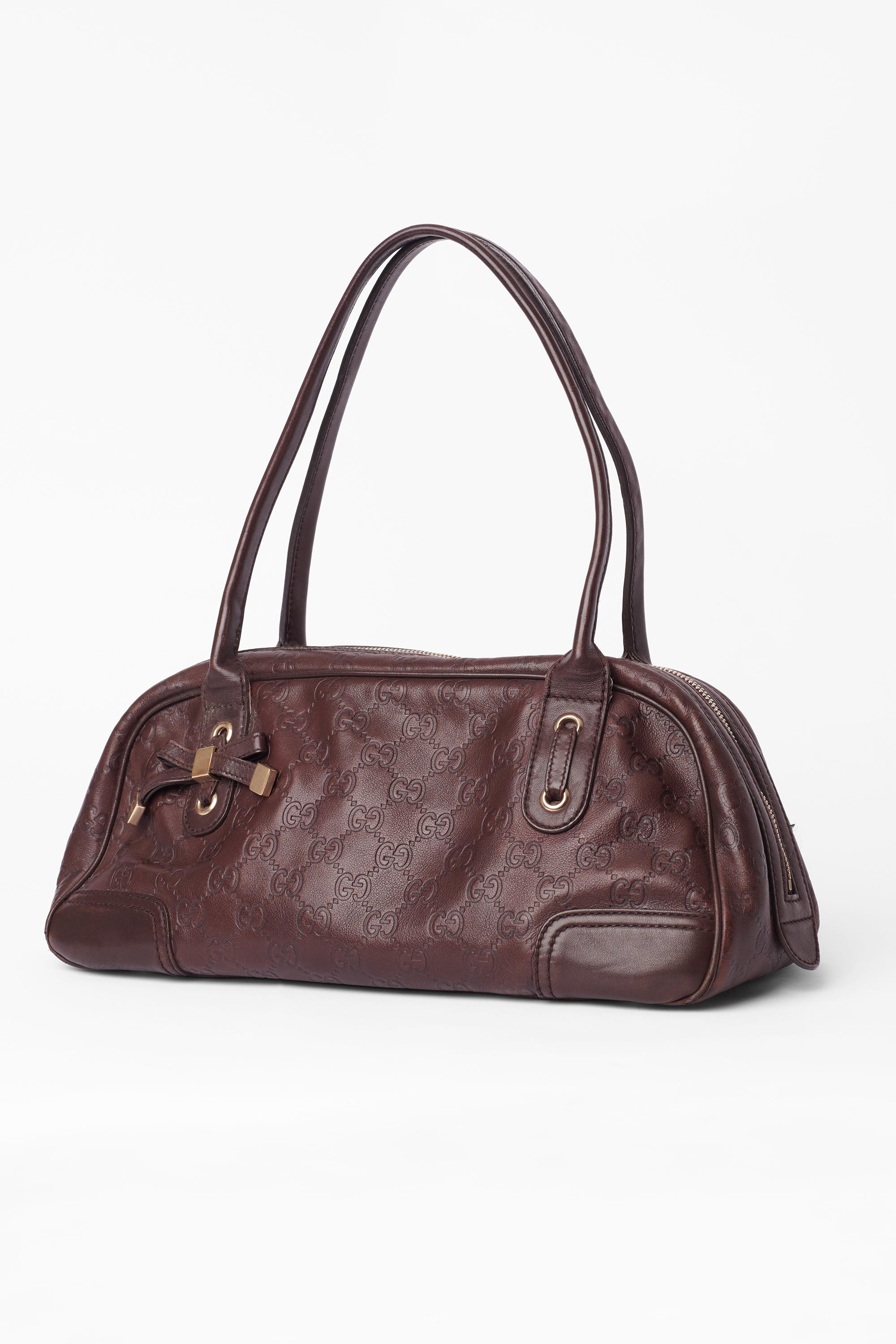 Vintage brown Guccissima leather princy boston shoulder bag. Features iconic GG monogram all over, front leather bow detail, lining in tricolour logo canvas, inner back zip pocket. Fasten with two double top zip.

Brand: Gucci
Color: Brown
Year /