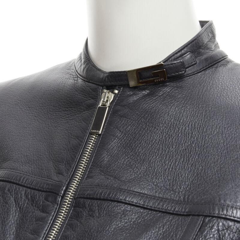 GUCCI 1996 Vintage Tom Ford black leather G logo buckle biker jacket IT40 S
Reference: GIYG/A00161
Brand: Gucci
Designer: Tom Ford
Collection: Fall Winter 1996
Material: Leather
Color: Black
Pattern: Solid
Closure: Zip
Extra Details: Signature Tom