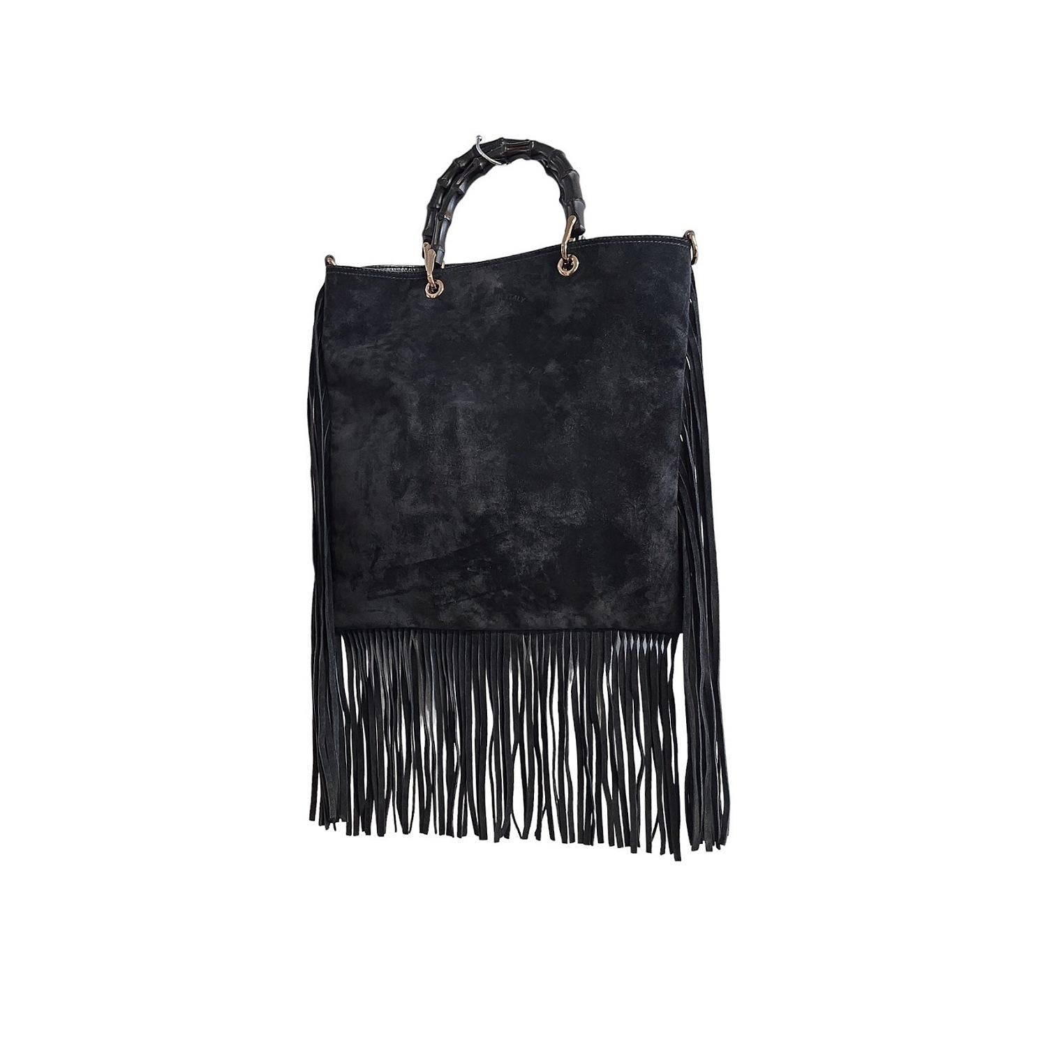 Elevate your style with this expertly crafted Gucci Suede Bamboo 2-way Tote. Made in Italy with luxurious black suede leather and light gold-tone hardware, it features round bamboo top handles for a touch of natural elegance. With a spacious