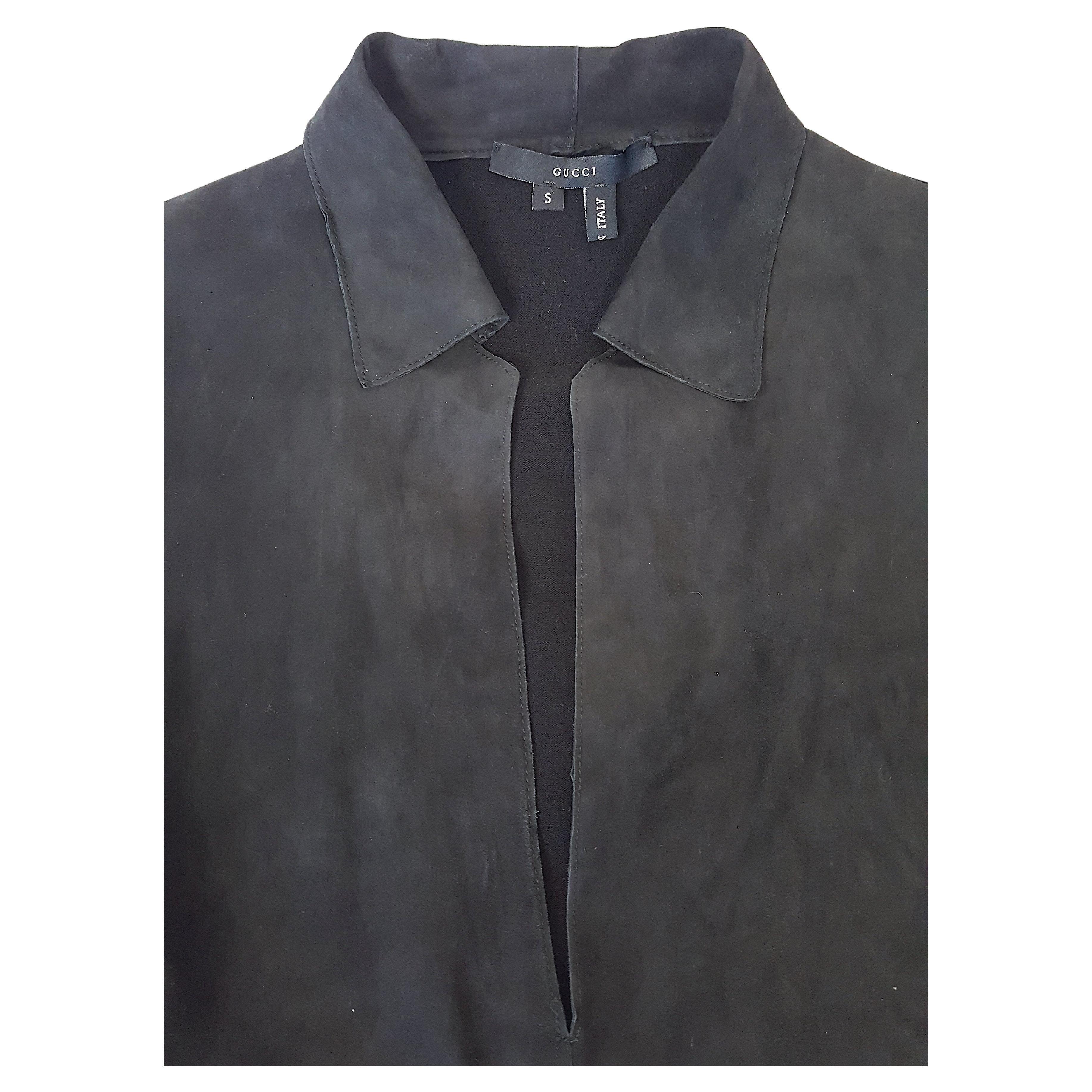 For his Gucci Fall/Winter 2001 collection, American Tom Ford designed this sleek partly-knit pullover tunic with plunging V-neck collared suede front that drapes in a reverse V-shape on the torso. It is paired for warmth with stretch-wool on the