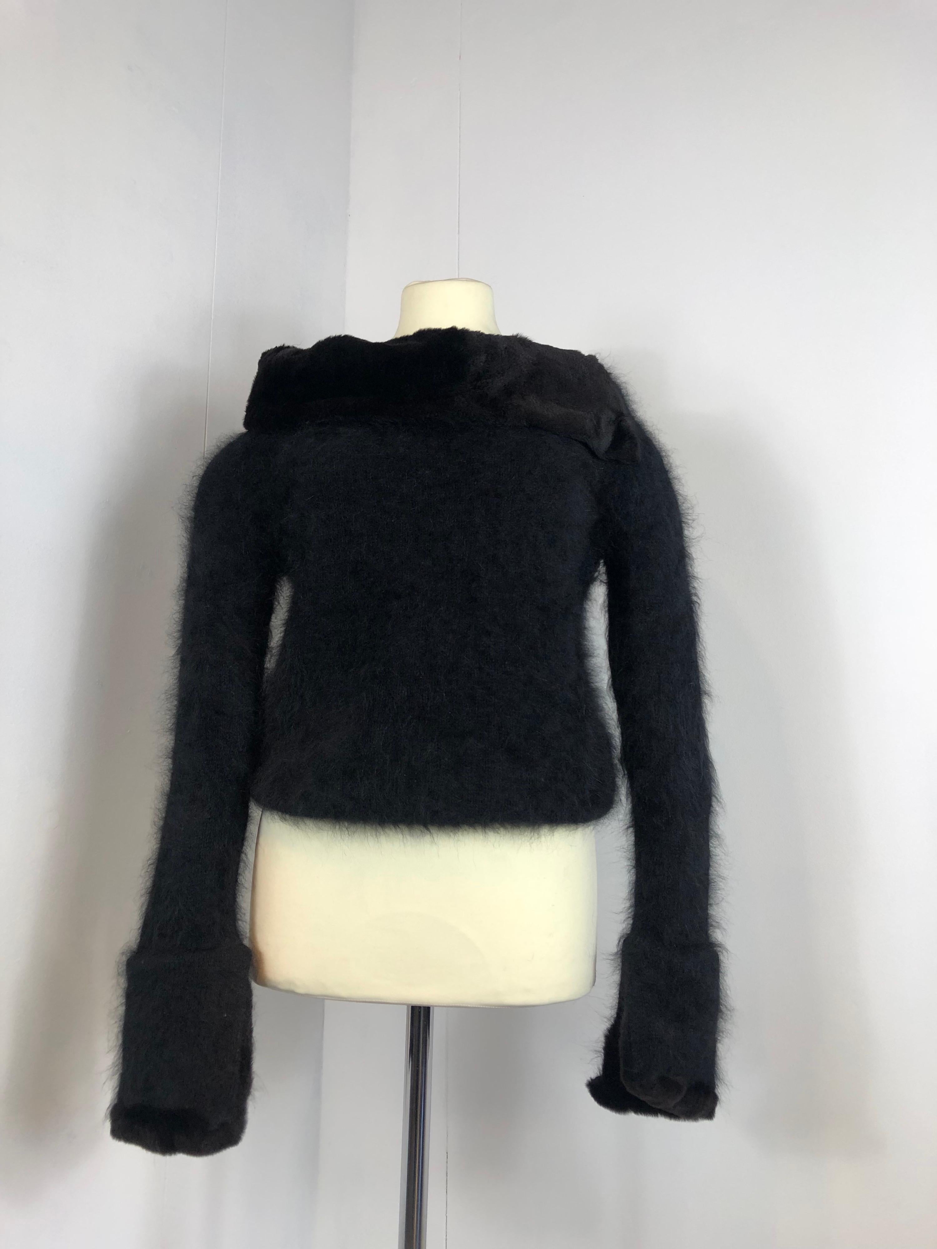 Gucci black jumper. Iconic piece.
Coming from 2001 collection by Tom Ford.
Made by angora and nylon. Details (neck+ end of the sleeves) in real fur. 
It comes with the original clothe hanger.
Size S. 
Measurements:
Shoulders 42 cm 
Bust 42 cm