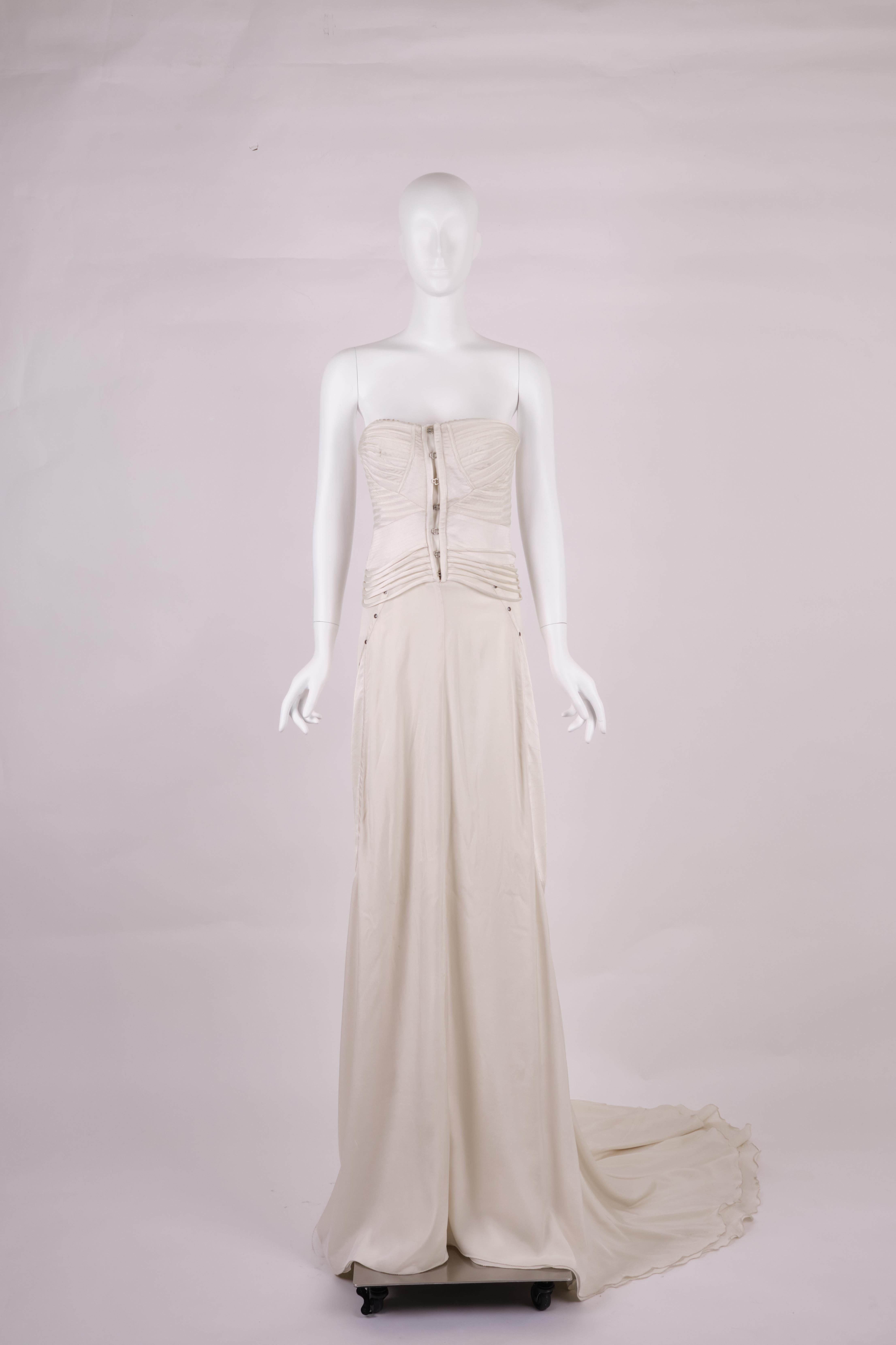 Gucci 2003 Wedding Corset Dress by Tom Ford. Crafted from luxurious red silk, this trained evening gown features exquisite appliquéd ribbons on the bodice, a central hook closure, and four buckle fastenings at the sides.

The addition of a dramatic
