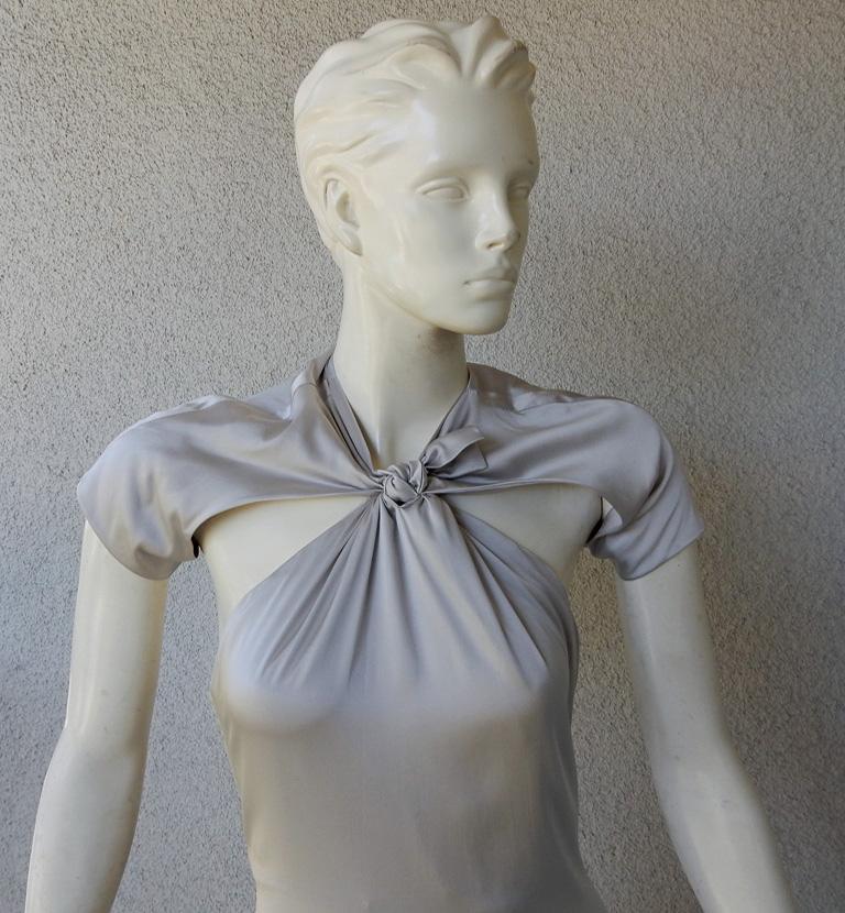 Sleek and chic Tom Ford's 1930's style gown for Gucci showcases a bias cut silhouette coveted by many.  Designed with cut out  bodice with center tie and dramatic open back with train.  Lined.

Condition: new condition; unworn

size: 44; bust: to